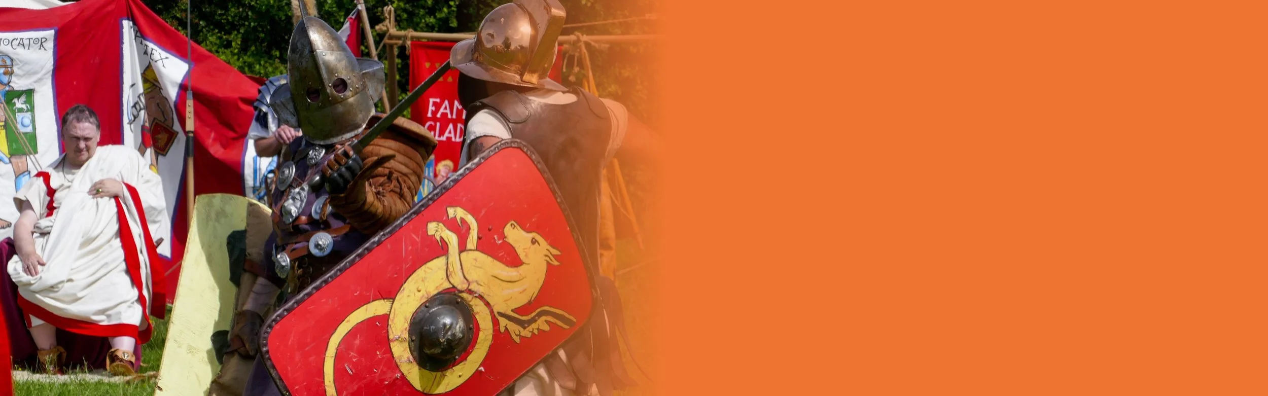 Two men dressed as roman gladiators are fighting each other with swords