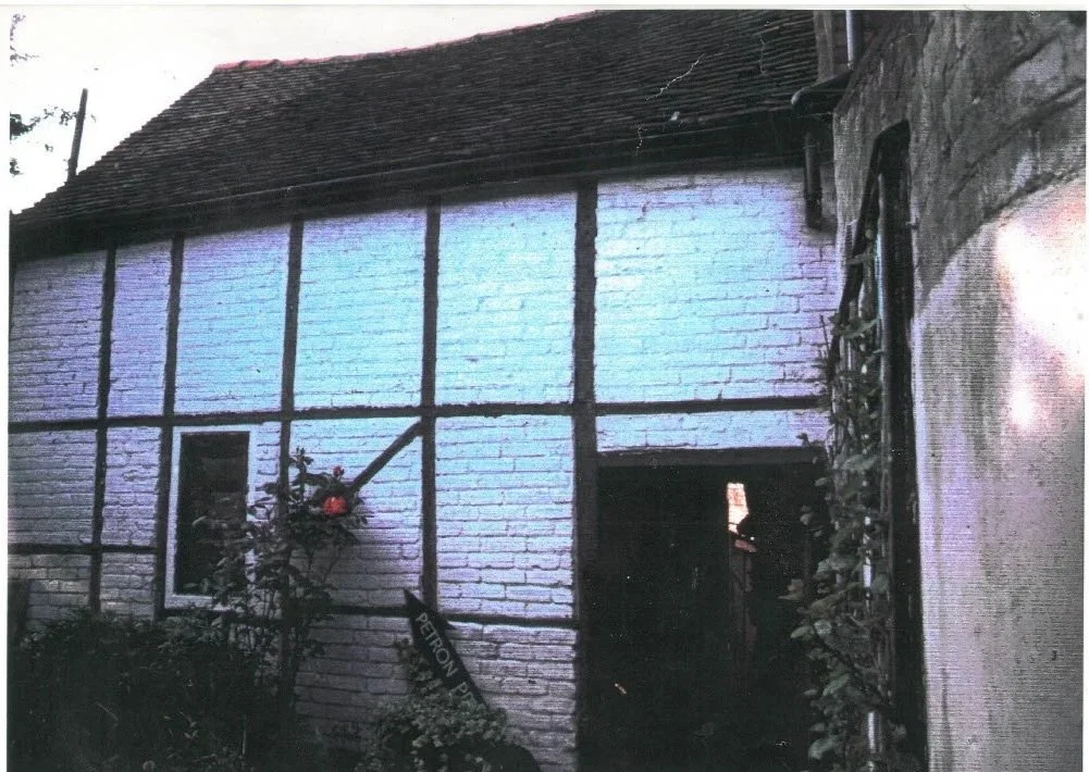 exteror of white building with brick infill panels