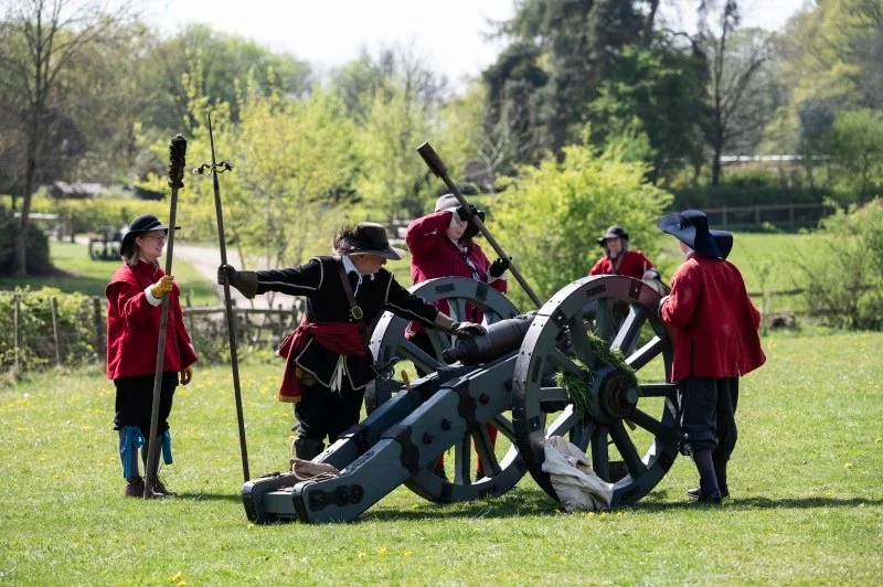 An English Civil War cannon being loaded by re-enactors