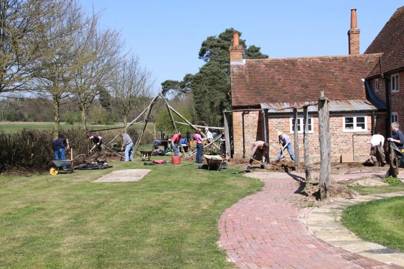 people working in an empty garden