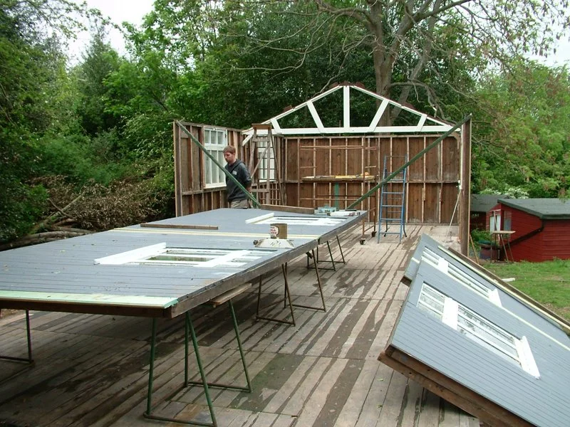 walls being put up on wood-framed building