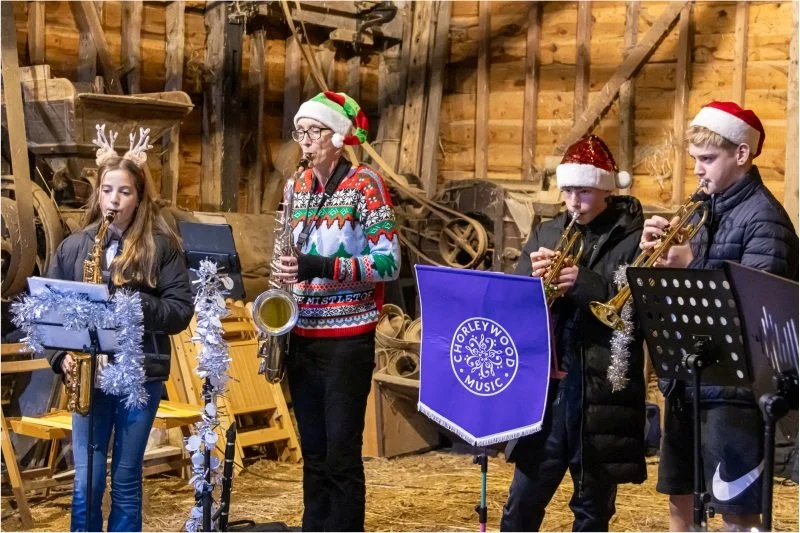 Local musicians playing saxophones and trumpets during the Festive Weekend