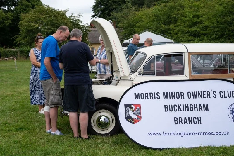 A vintage Morris Minor car on display at a classic vehicles show