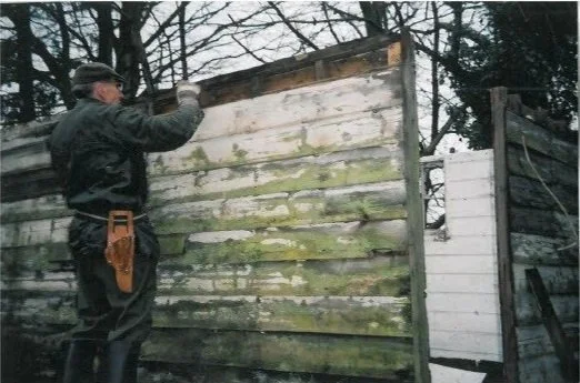 Man removing wooden slats from living van