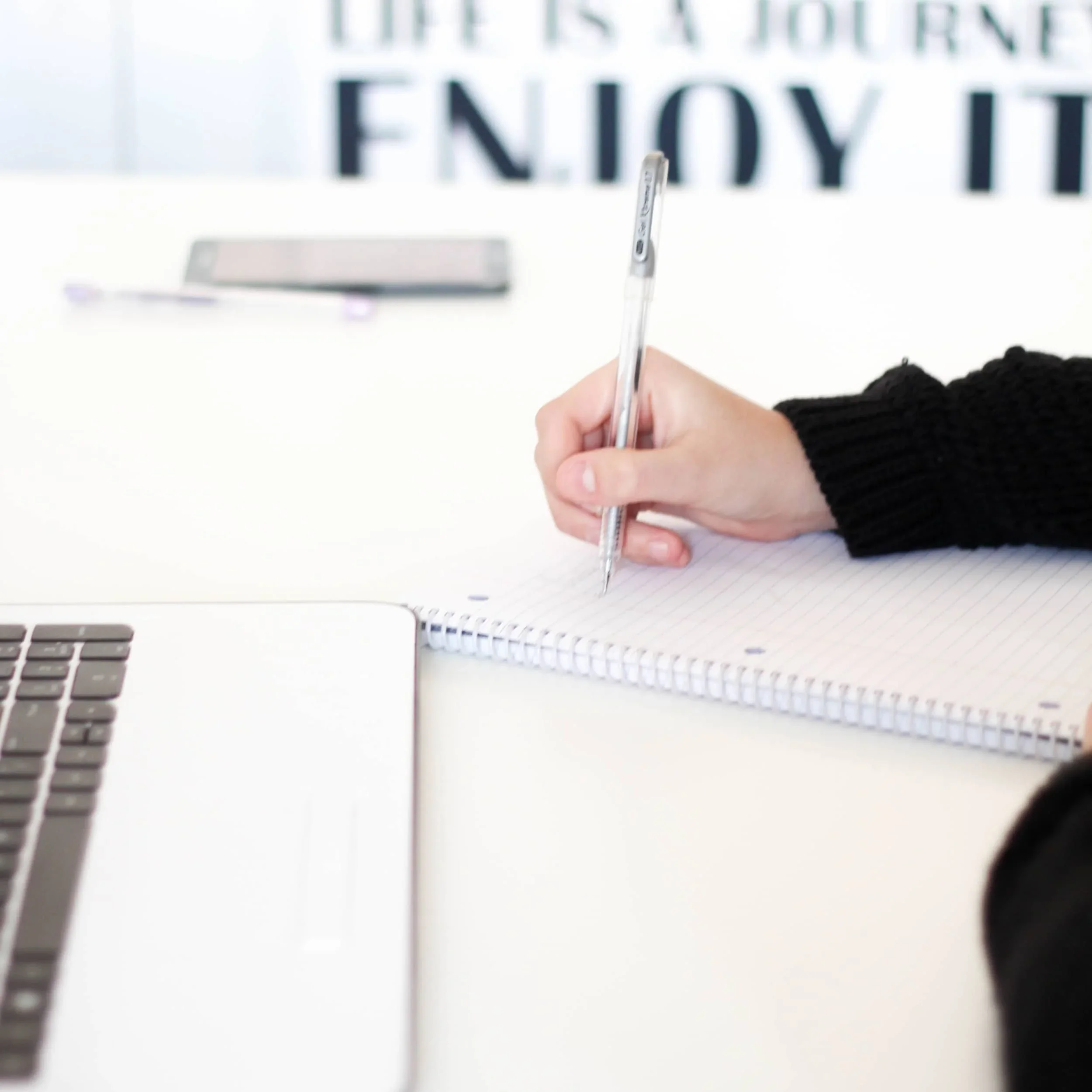 White Woman writing in a notebook