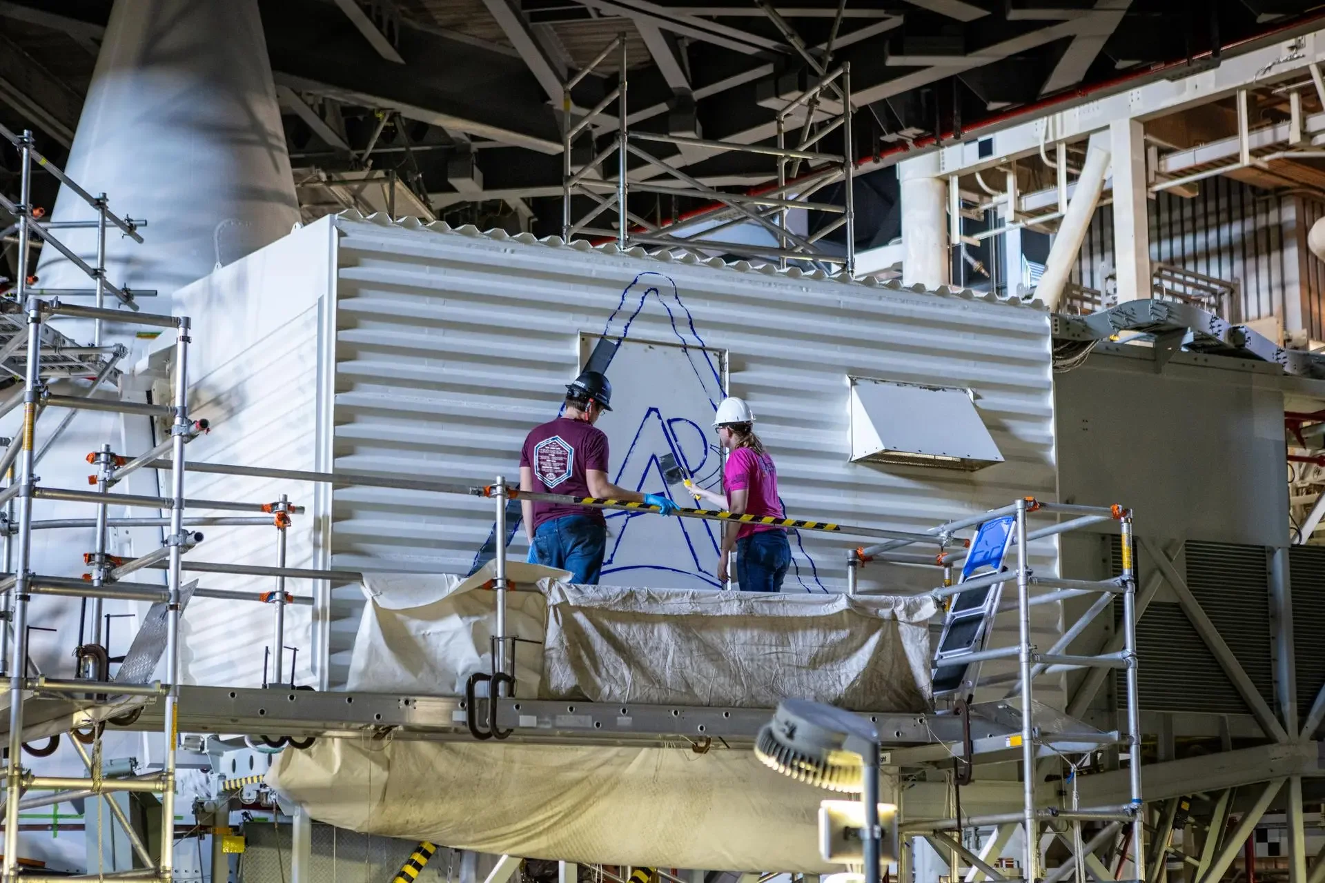 NASA is investing approximately $10.5 million in seven State Hubs intended to build pathways into skilled technical aerospace careers. The image shows technicians working inside the Vehicle Assembly Building at Kennedy Space Center.
