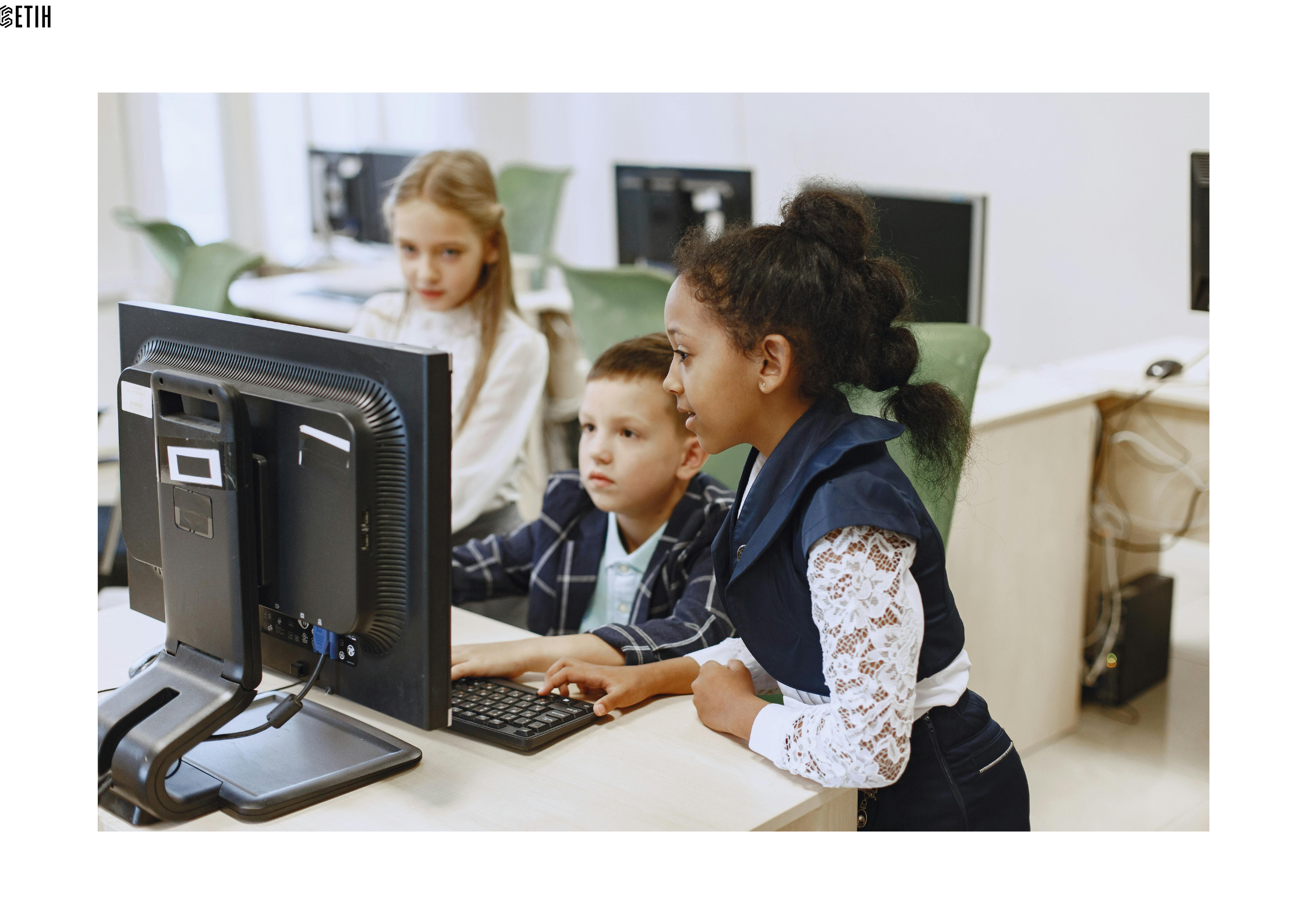 Pictured are three pupils, two girls and boy, working on a laptop
