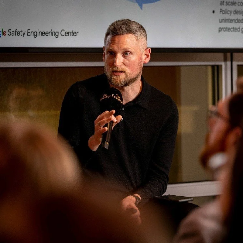 John Buckley speaking at an online safety event while holding a microphone. Buckley has joined OpenAI after holding child safety and policy roles at the LEGO Group, Google, YouTube, Facebook, and Instagram.