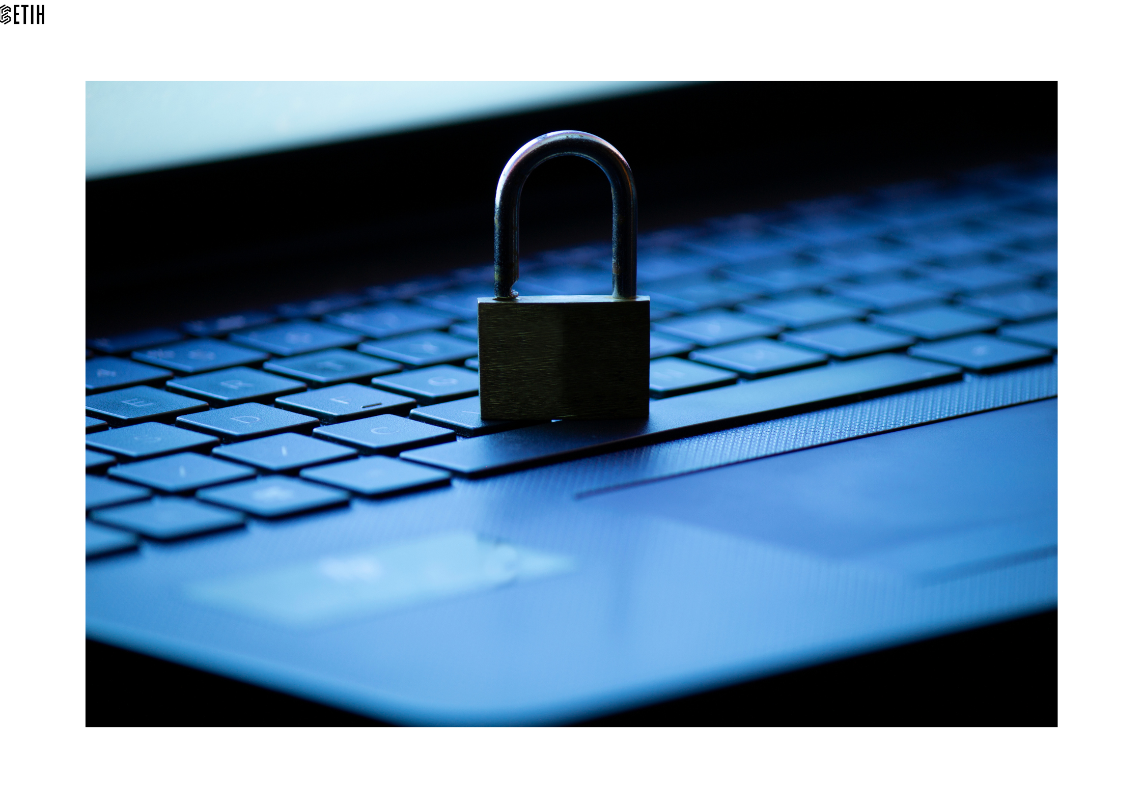 Pictured is a padlock on top of a laptop keyboard, illustrating the lack of protections on many teachers' devices