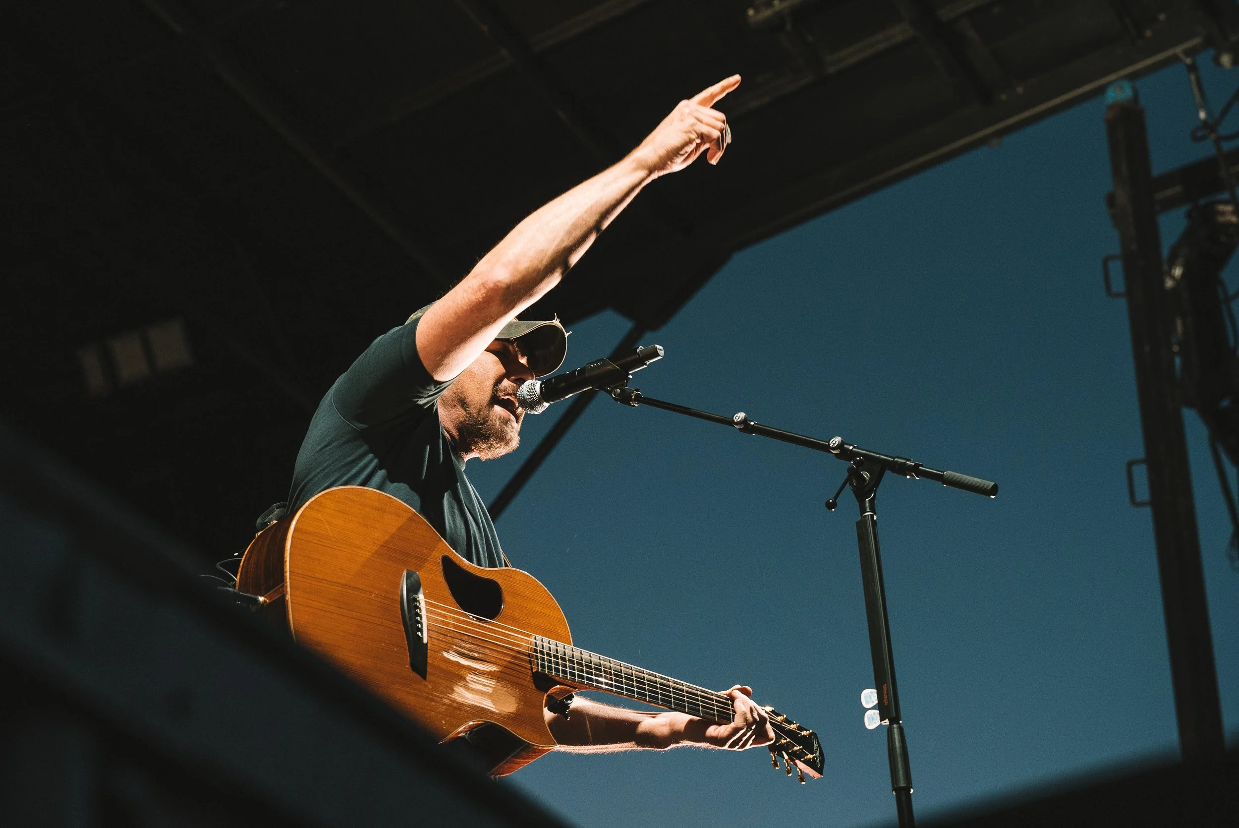 Rodney Atkins singing on stage at the Summit County Fairgrounds while pointing to the crowd in Coalville, Utah.