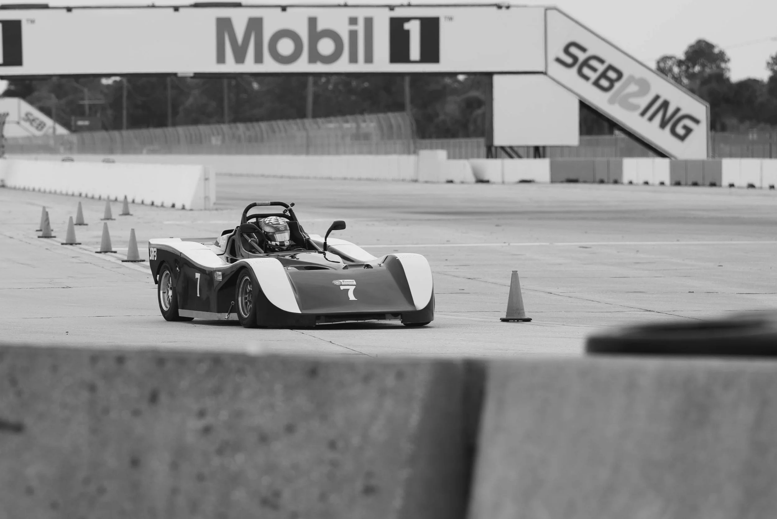 A Spec Racer Ford race car on the side of the track with the Mobil 1 sign behind at a SCCA race in Southern Florida.