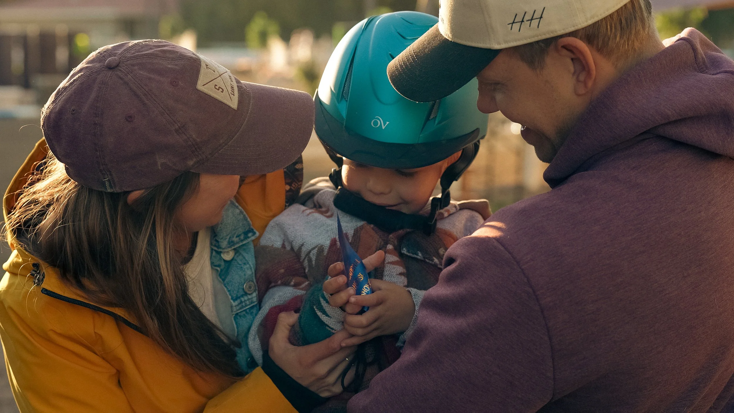 Family hugging after their little boy wins a blue ribbon