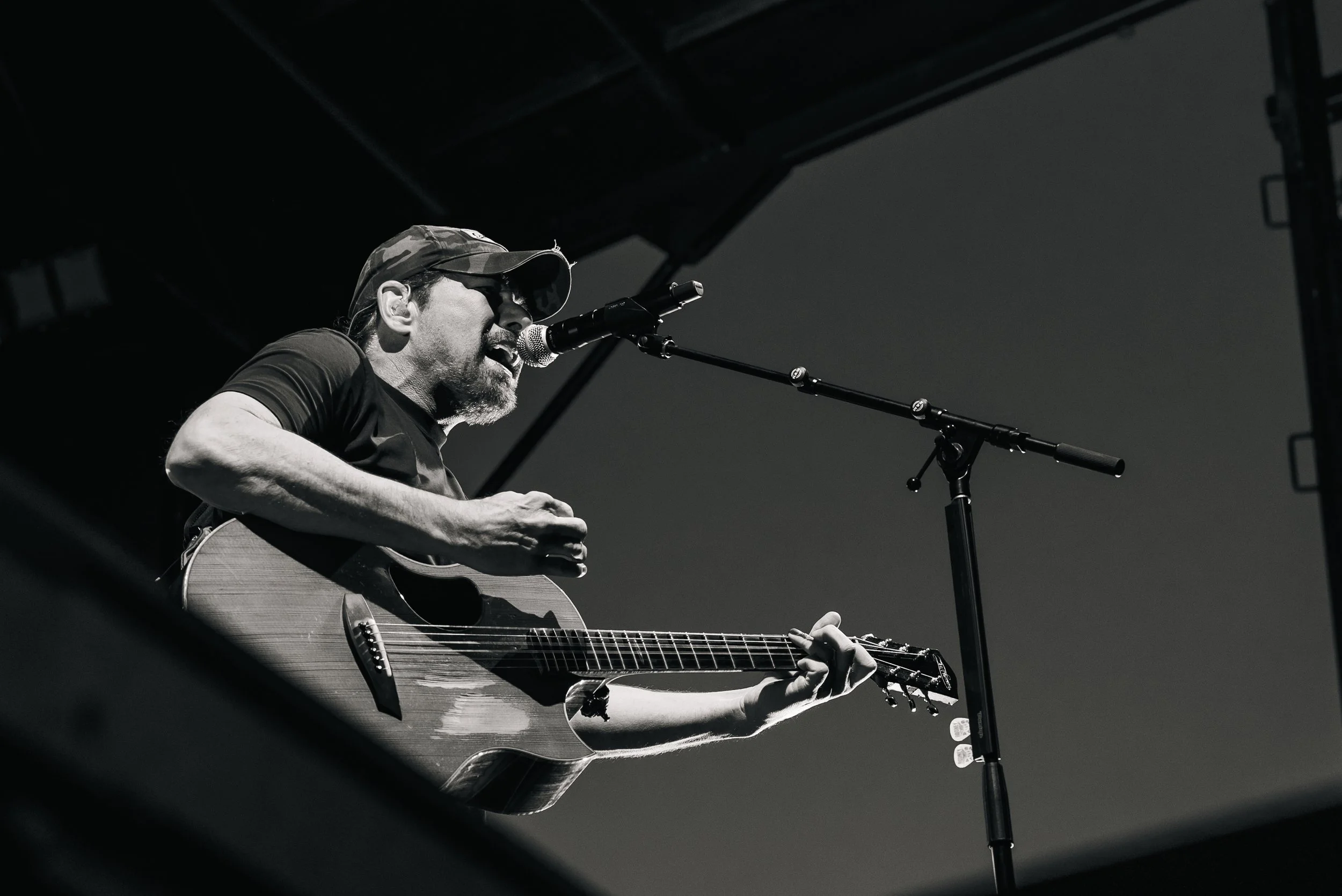 Rodney Atkins singing on stage while strumming his guitar at the Summit County Fairgrounds in Coalville, Utah.