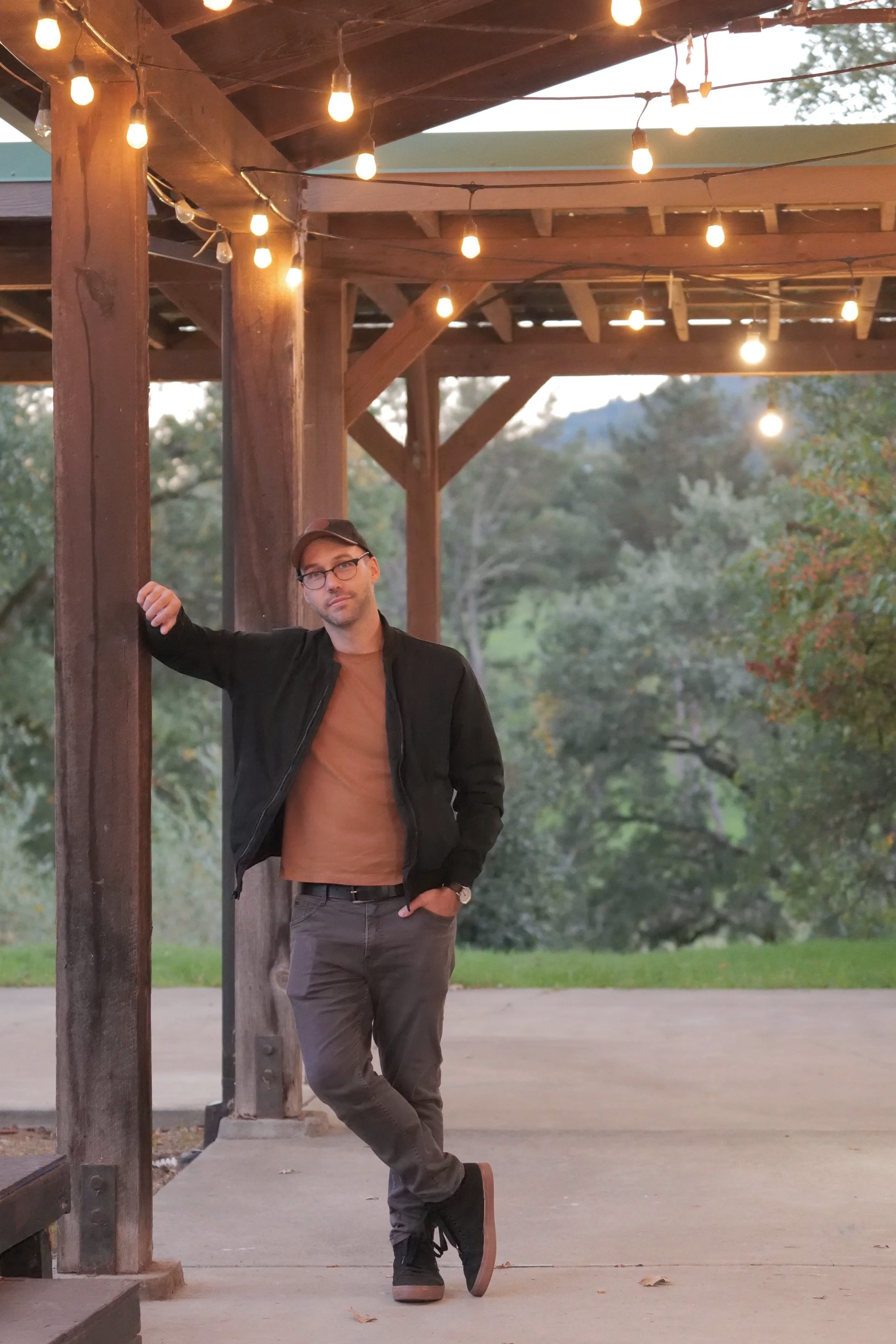 Cody standing under a covered walkway with hanging lights