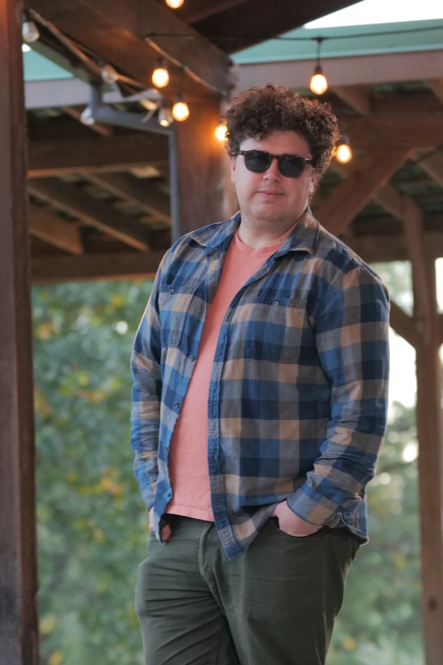 Scott stands under a covered walkway with hanging lights