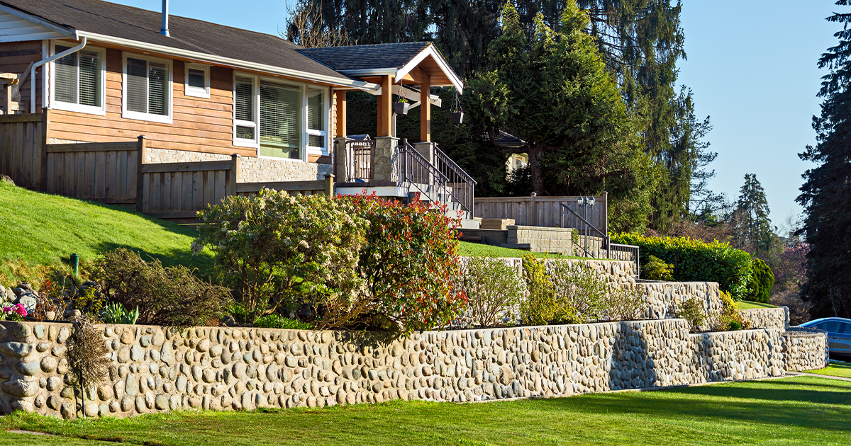 Sloped Property? Here's How Grading and Retaining Walls Can Transform It