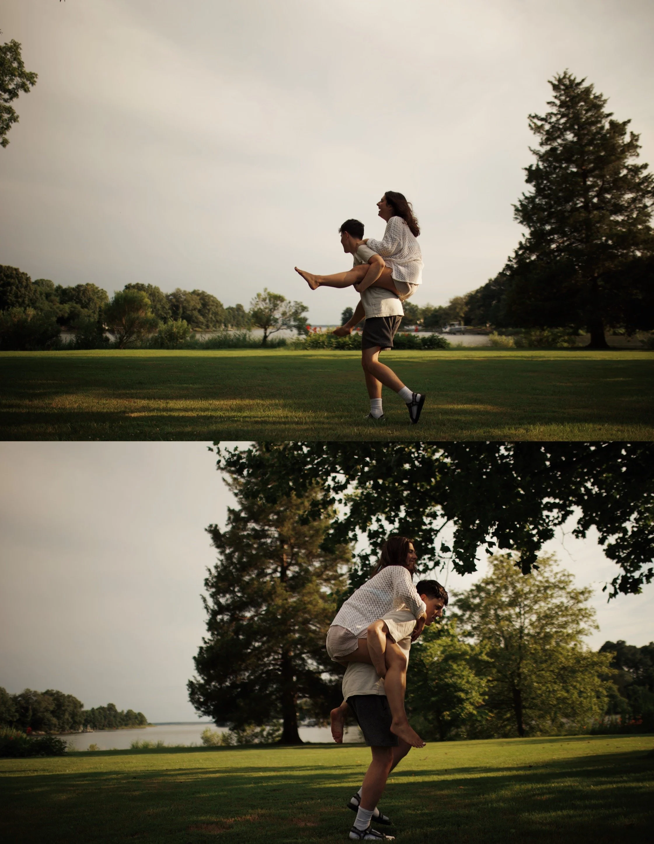 A man giving a woman a piggyback ride in a park with trees and a lake in the background during late afternoon or early evening.