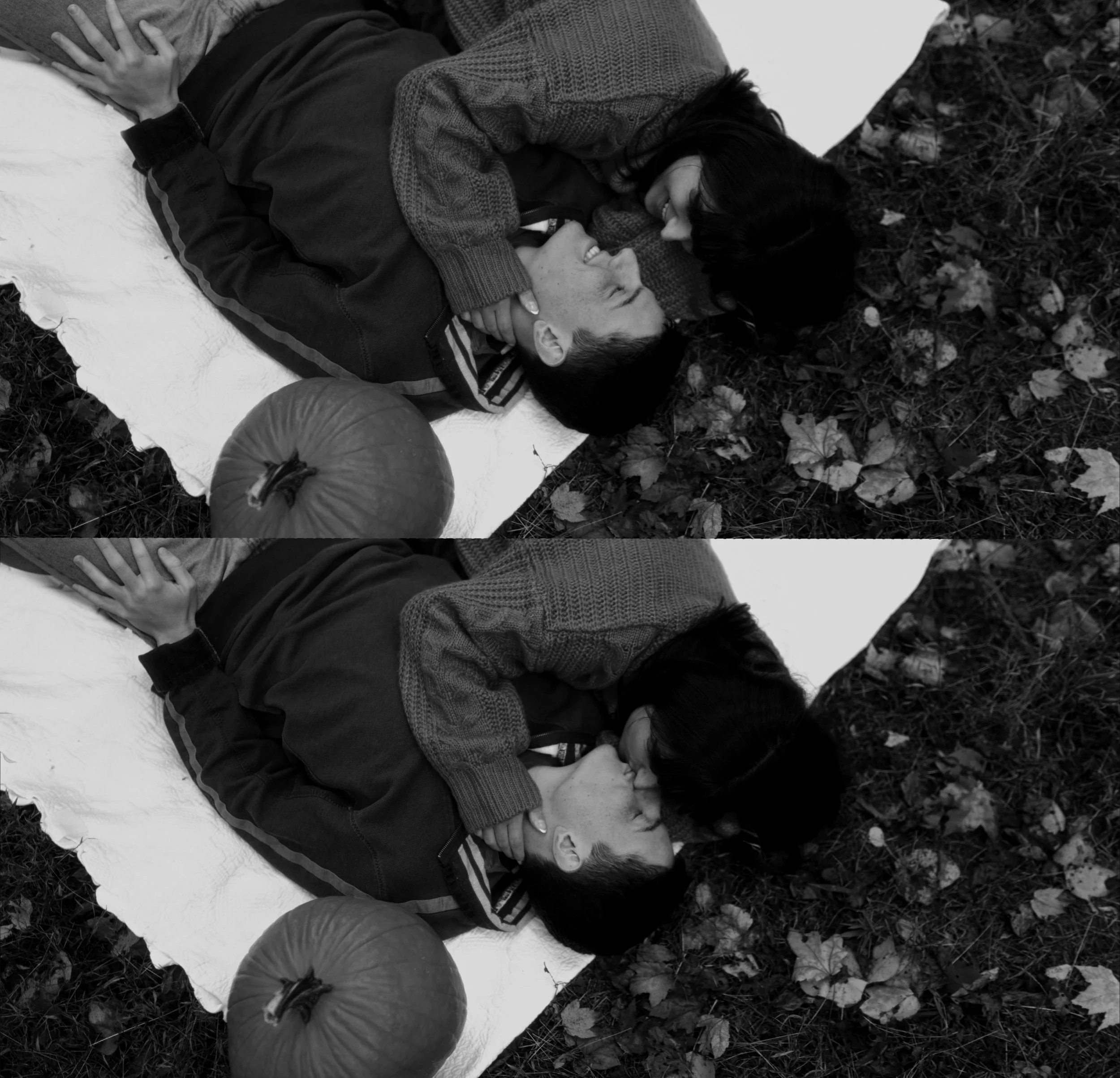 Two young people lying on a blanket outdoors, facing each other, sharing a kiss, with a pumpkin nearby, autumn leaves on the ground, in black and white.