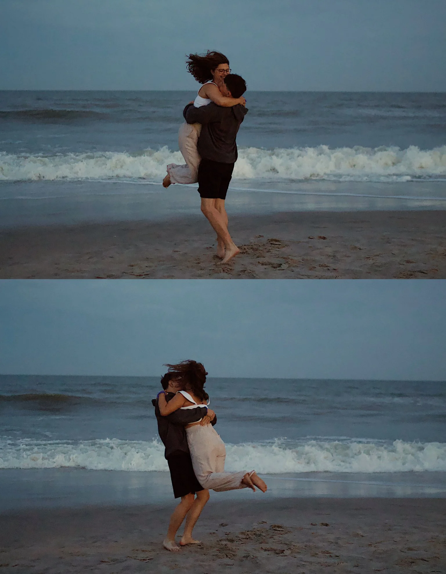 A couple embracing and playing on the beach near the ocean, with the woman being lifted by the man and both appearing happy.