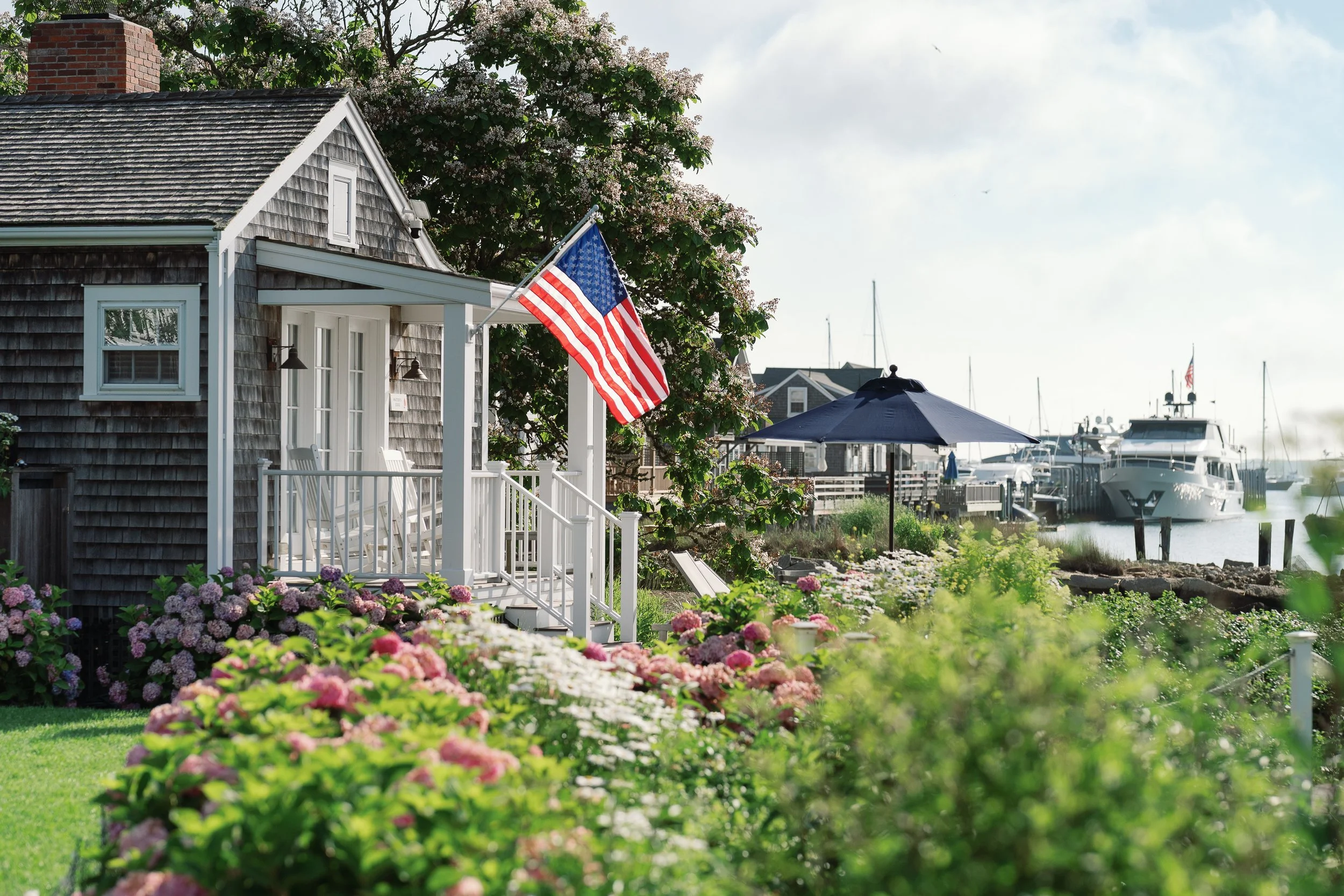 Water's Edge Cottage overlooking the harbor with big yacht