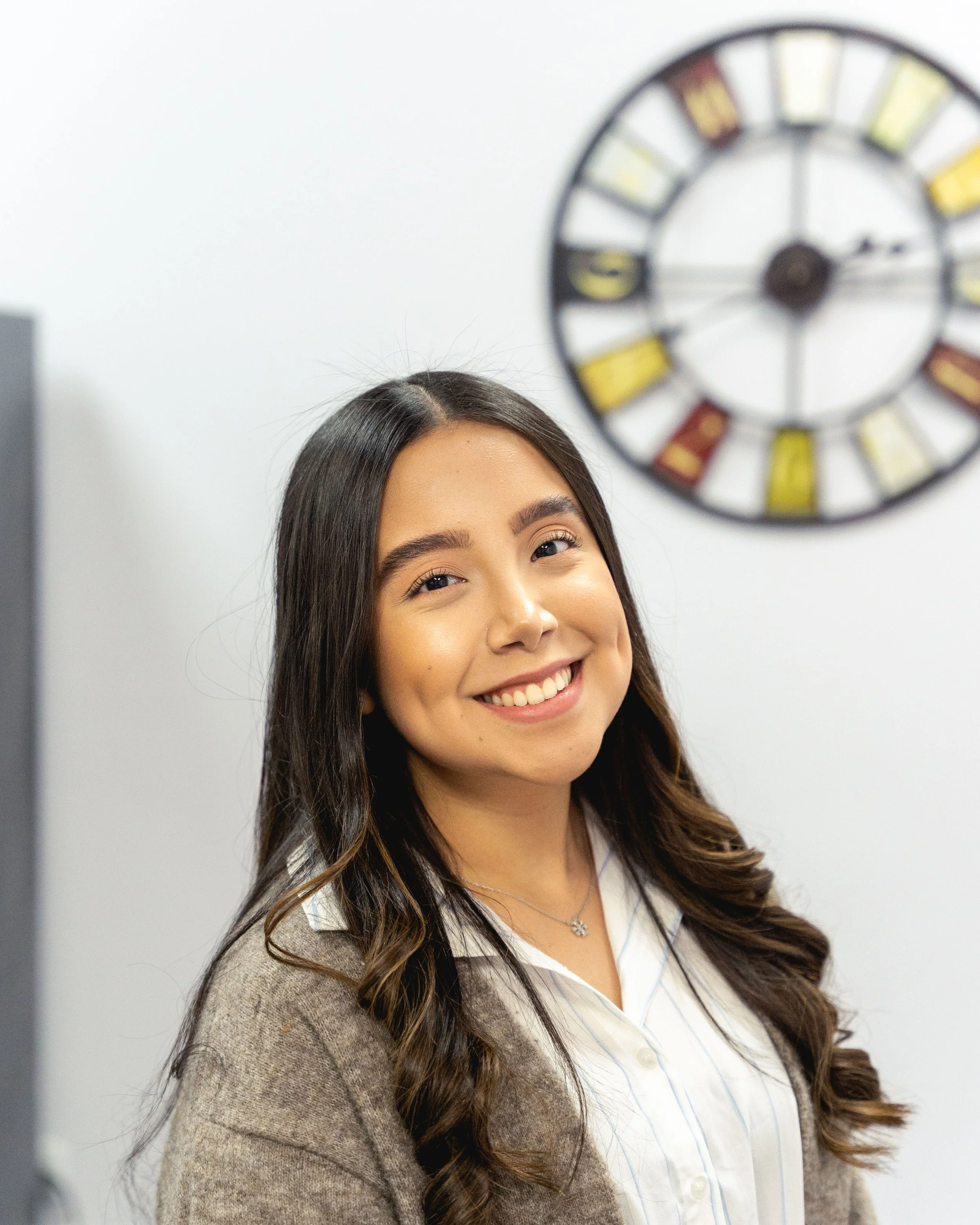 Woman smiling against a wall