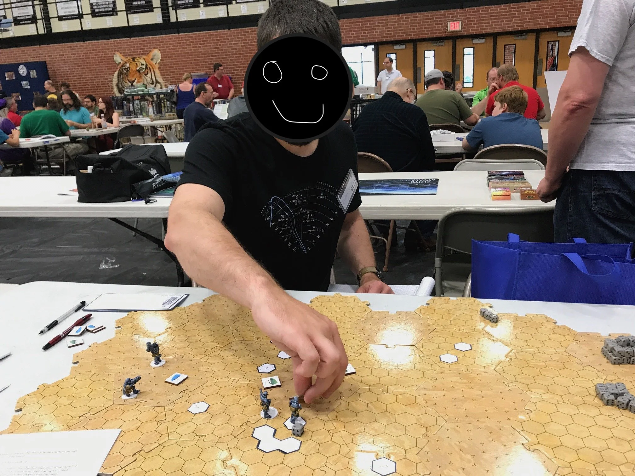 A player holding a game piece above a hexagon-shaped board