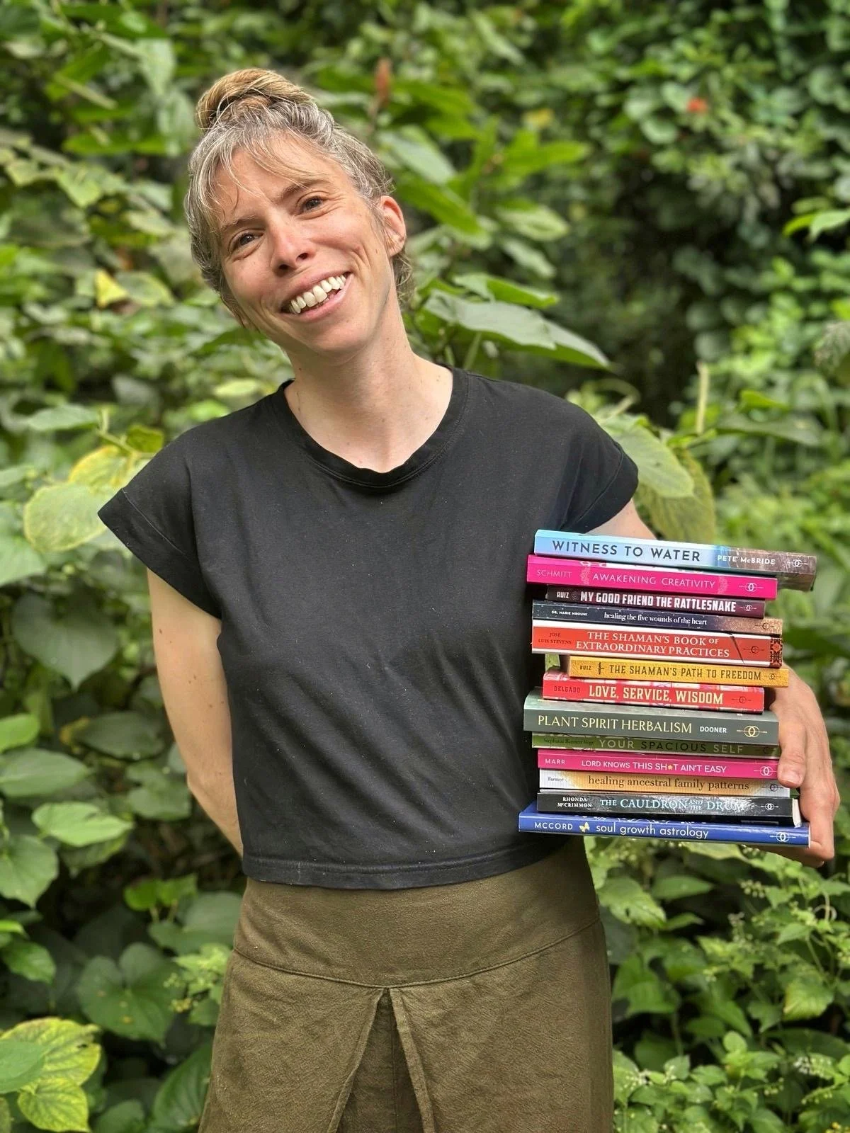 Photo of self-help editor with pile of books