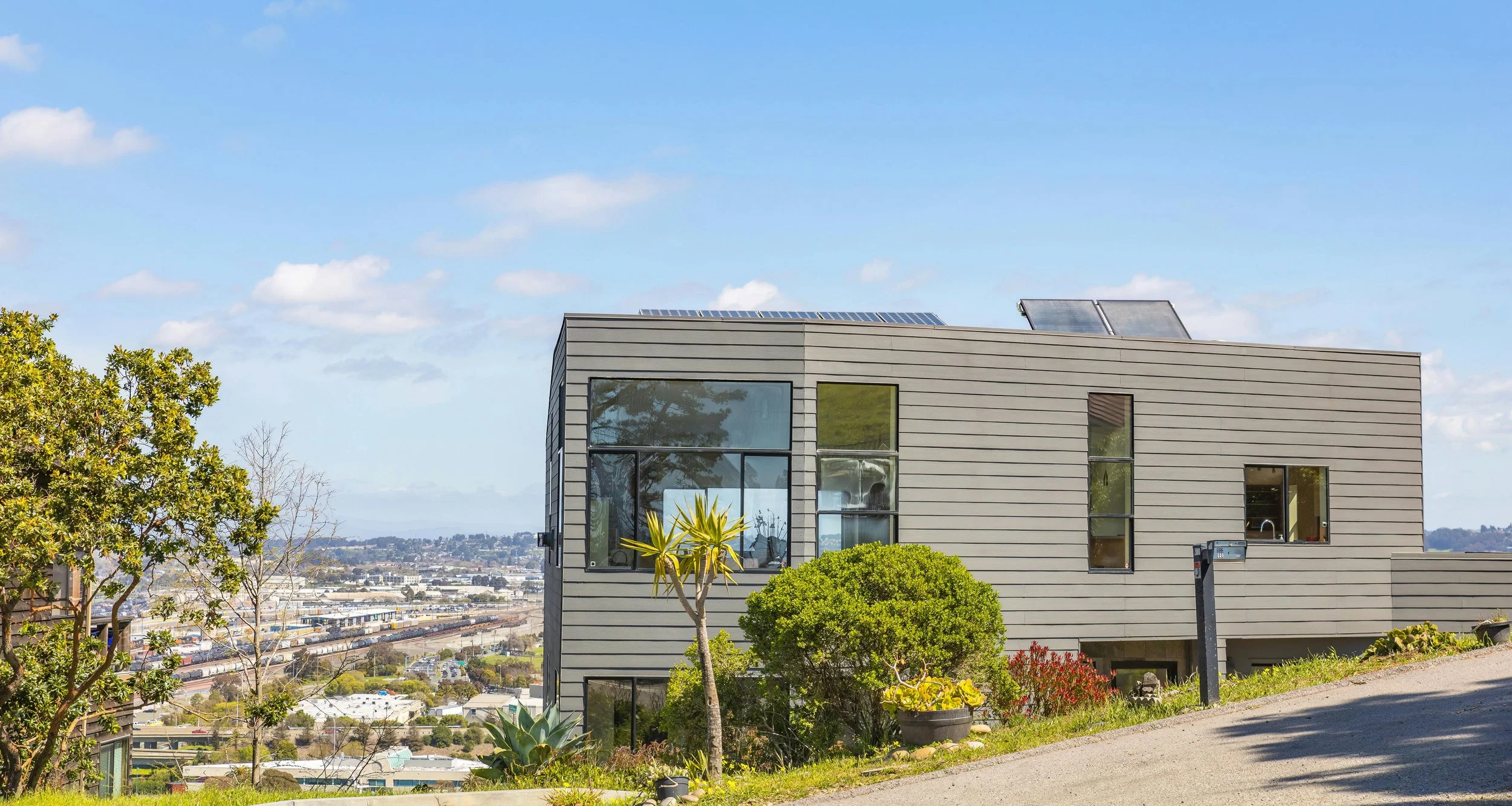 Modern home with rooftop solar panels, symbolising the hidden benefits of solar energy such as property value increase, energy independence, and clean power.