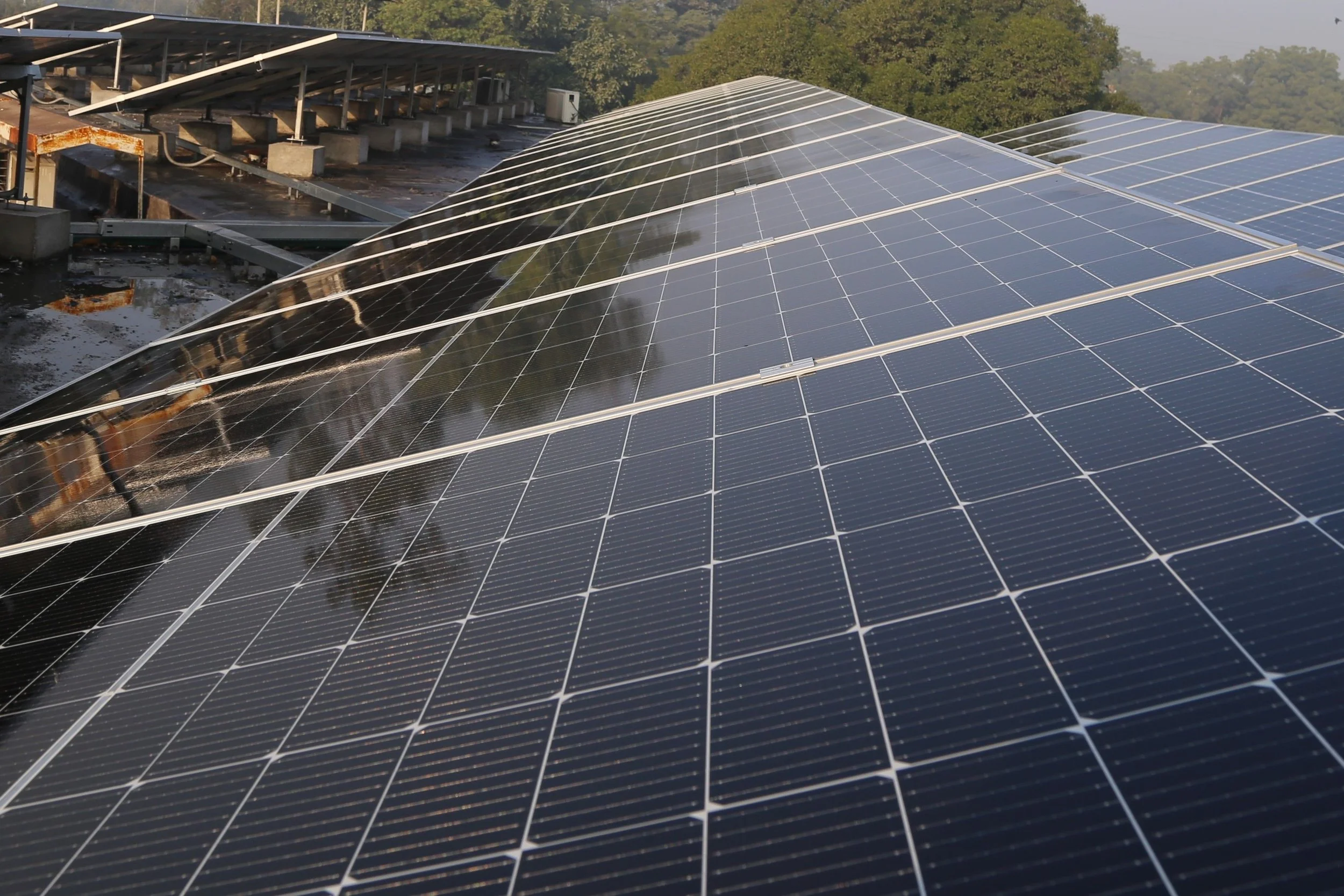 Wide view of solar panels installed on a rooftop, representing certified solar technology, clean energy, and sustainable electricity generation.