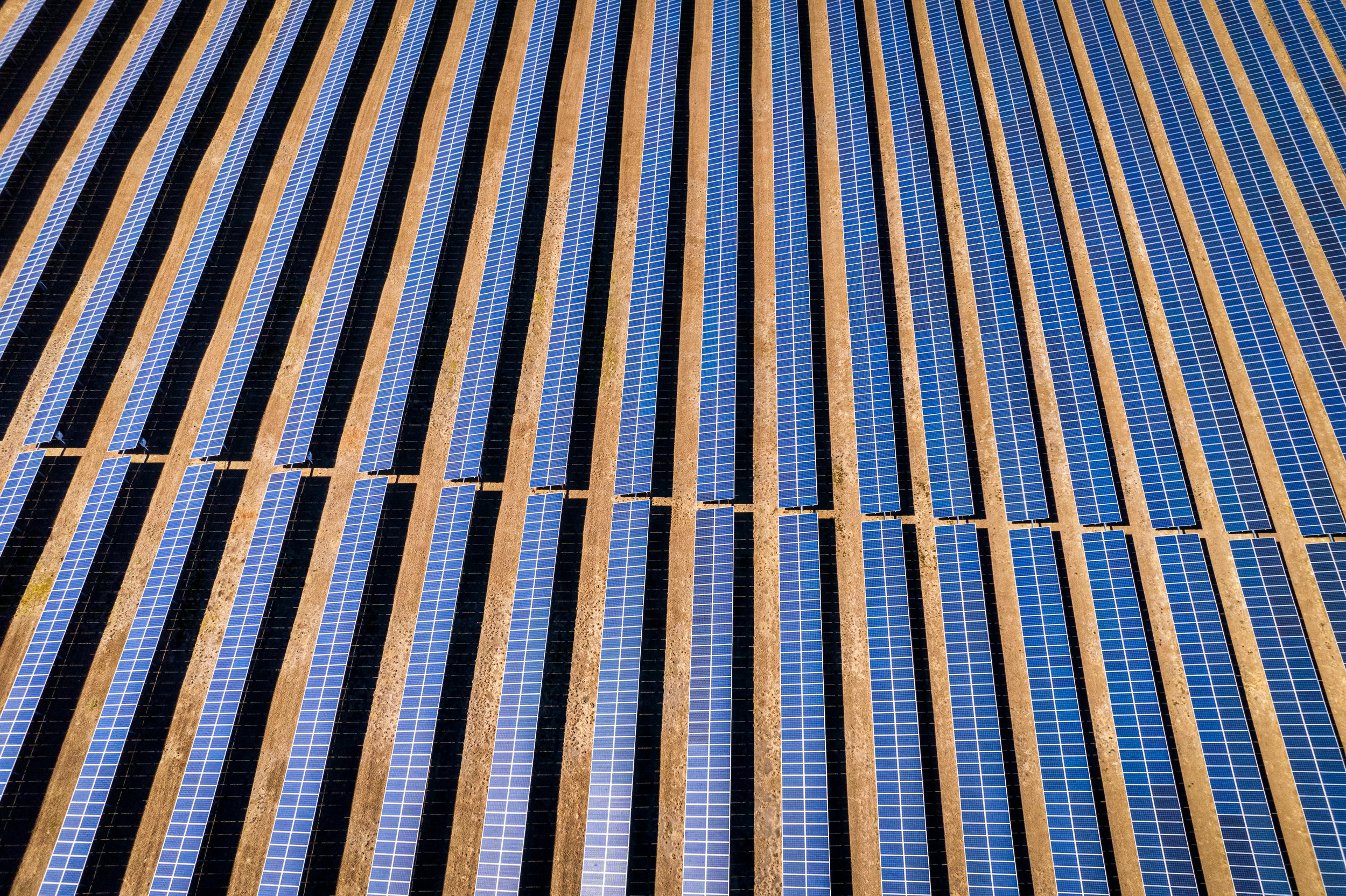 Drone shot of solar panels on rooftops, representing solar panel recycling and end-of-life sustainability.