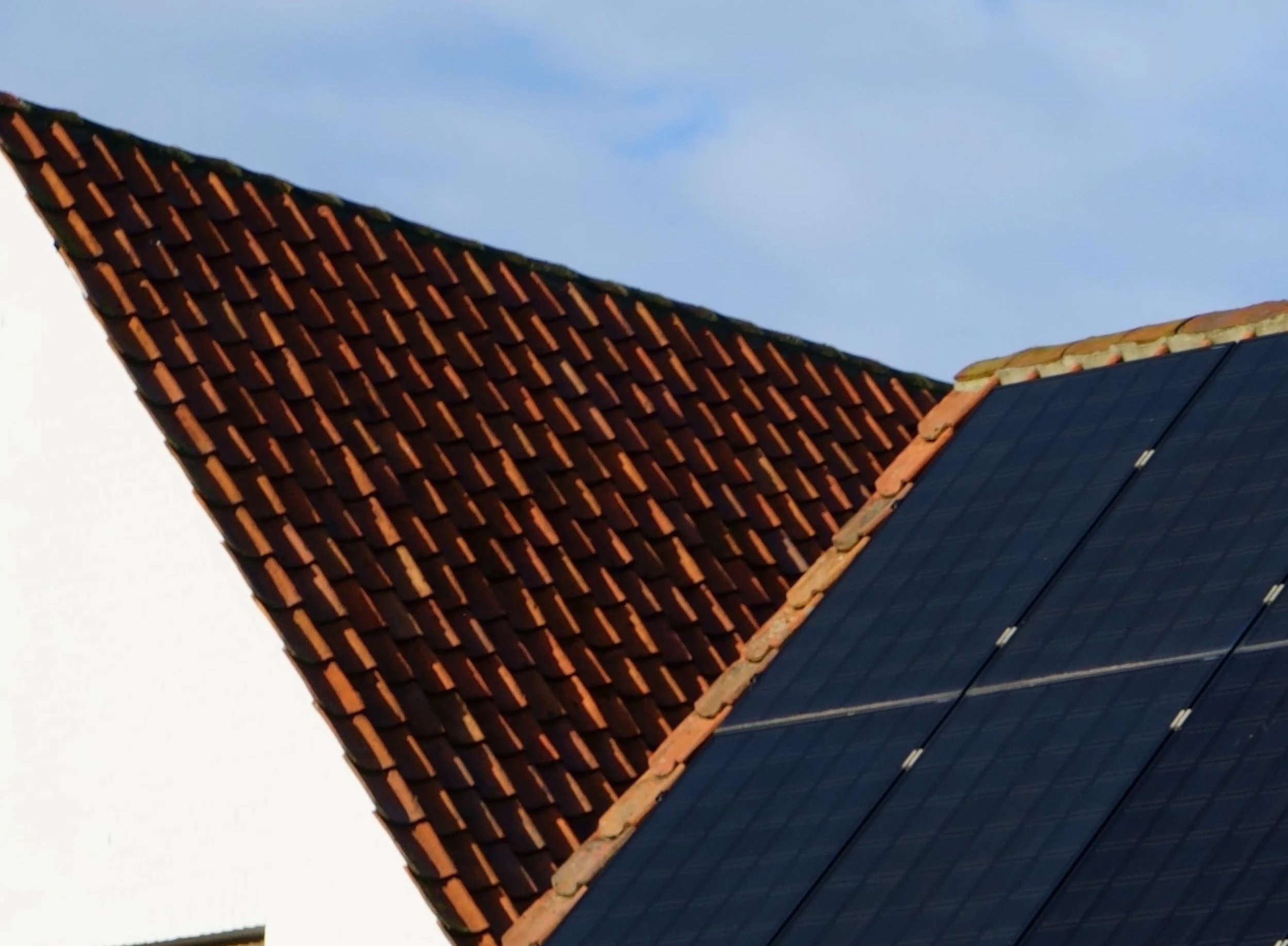 Close-up of solar panels installed on a tiled roof, highlighting renewable energy technology and efficient residential solar power generation.