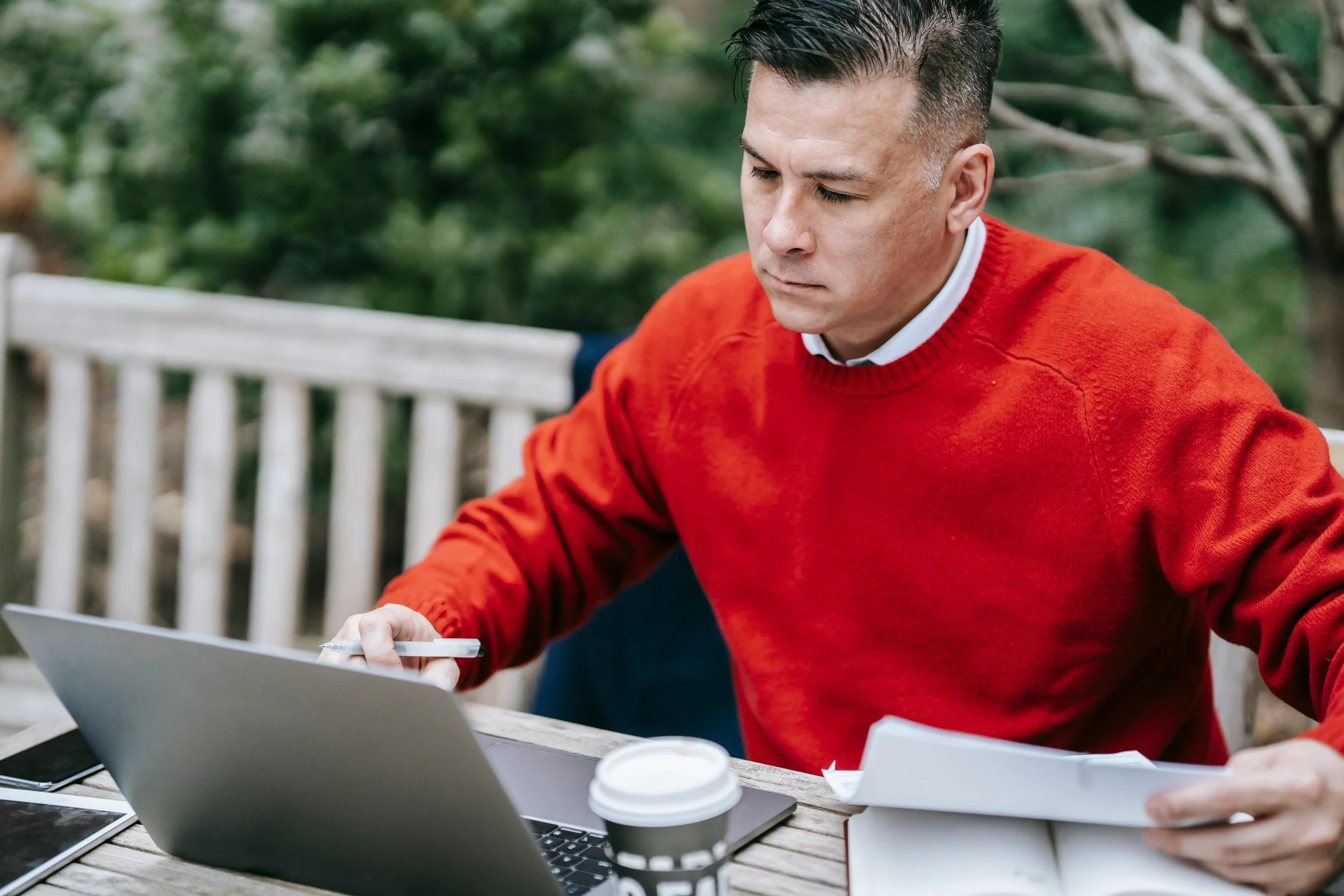A focused man sitting at a desk working on his laptop, representing productivity and professional growth in the workplace.