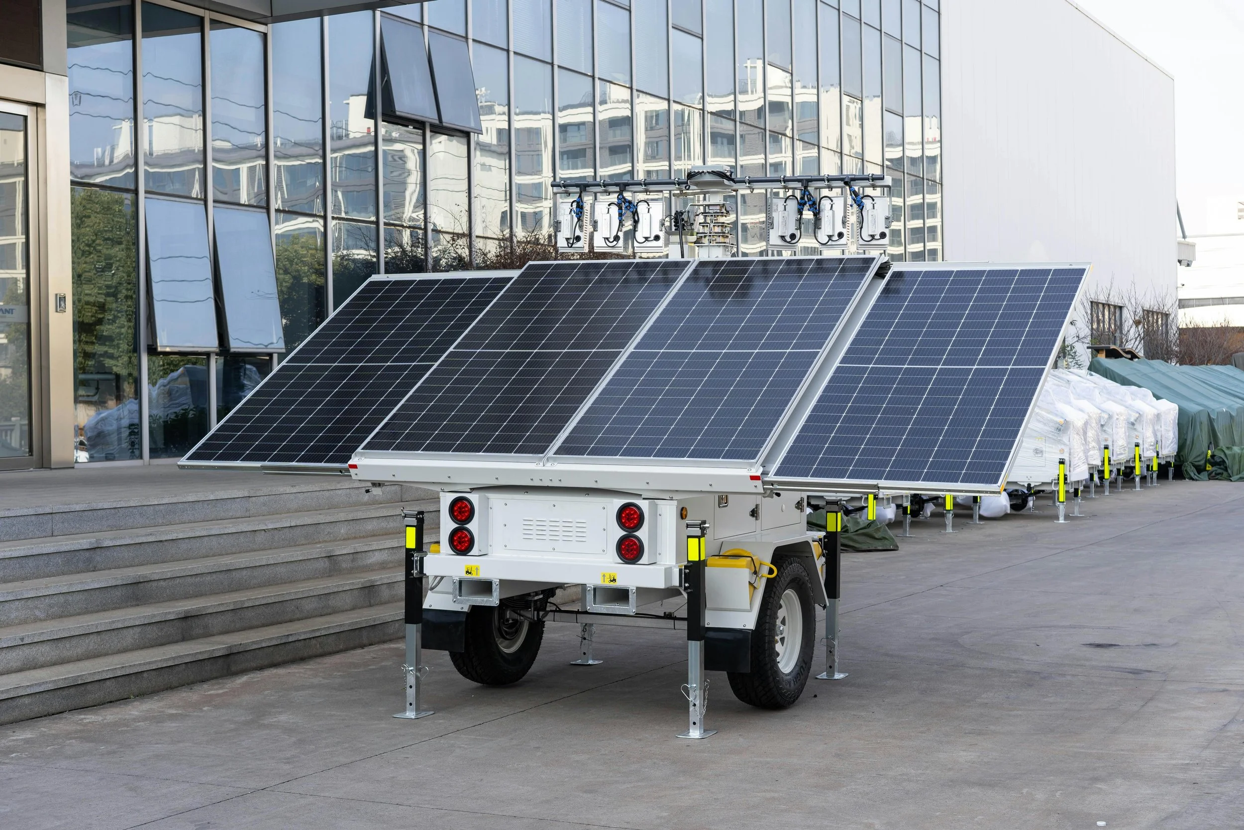 Mobile solar panel trailer set up in an urban environment, showcasing portable renewable energy technology for flexible power generation