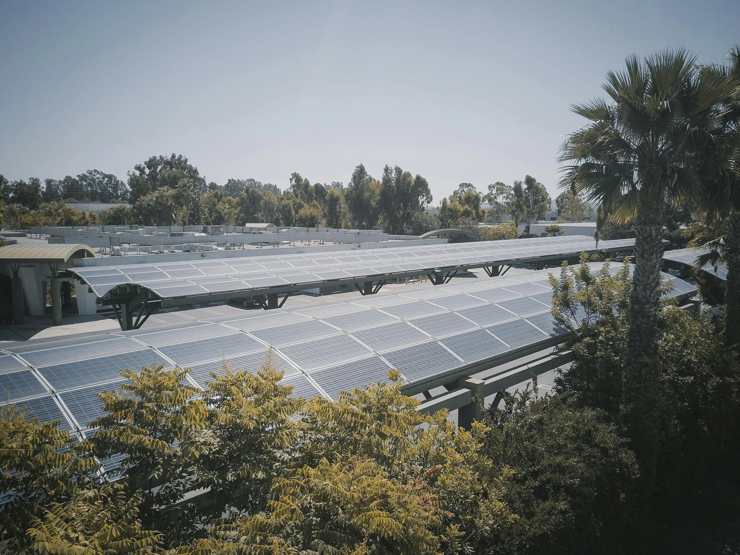 Futuristic solar panels under the sun with a glowing infrared overlay, symbolising the capture of invisible infrared light for enhanced energy efficiency.