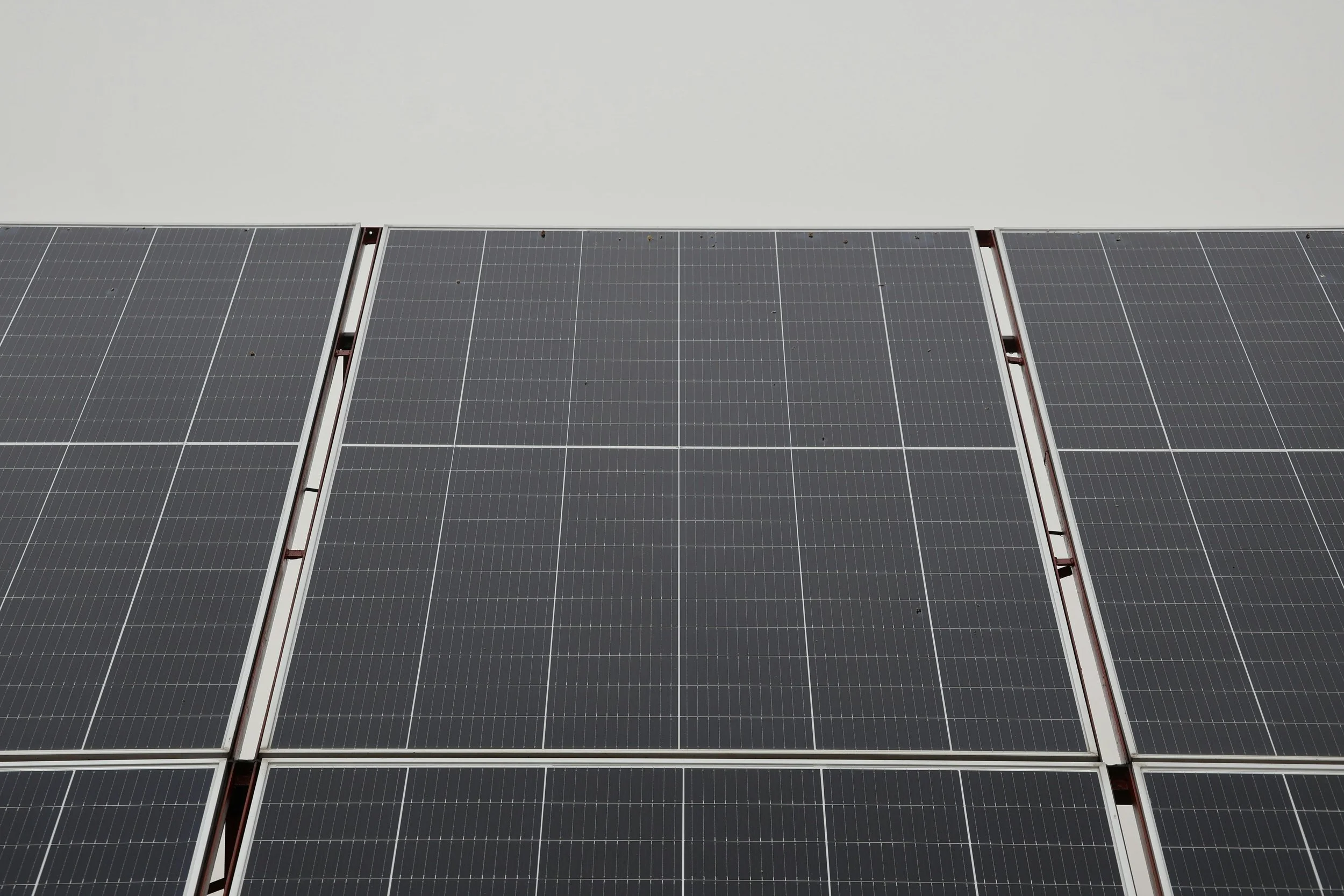Close-up of solar panels showing photovoltaic cells, highlighting solar energy generation and system performance details.