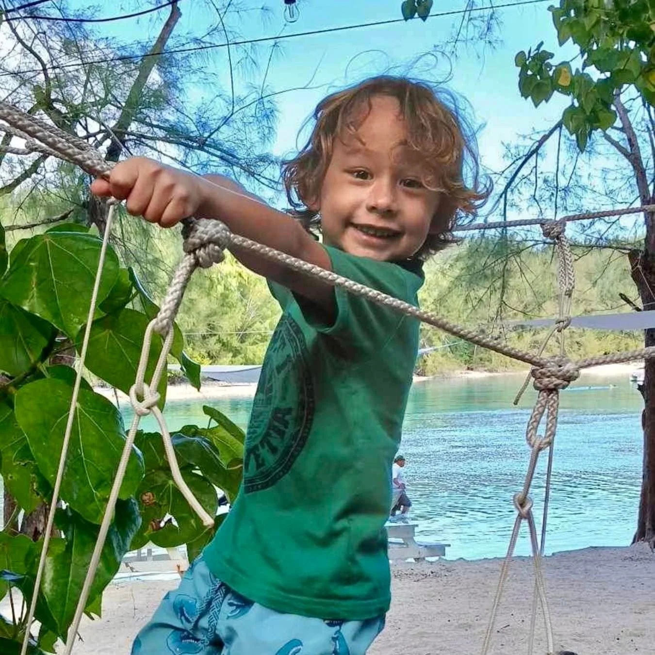 Enfants jouant sur une structure de jeu en plein air lors d’une sortie au motu organisée par l’École Fare Anuanua