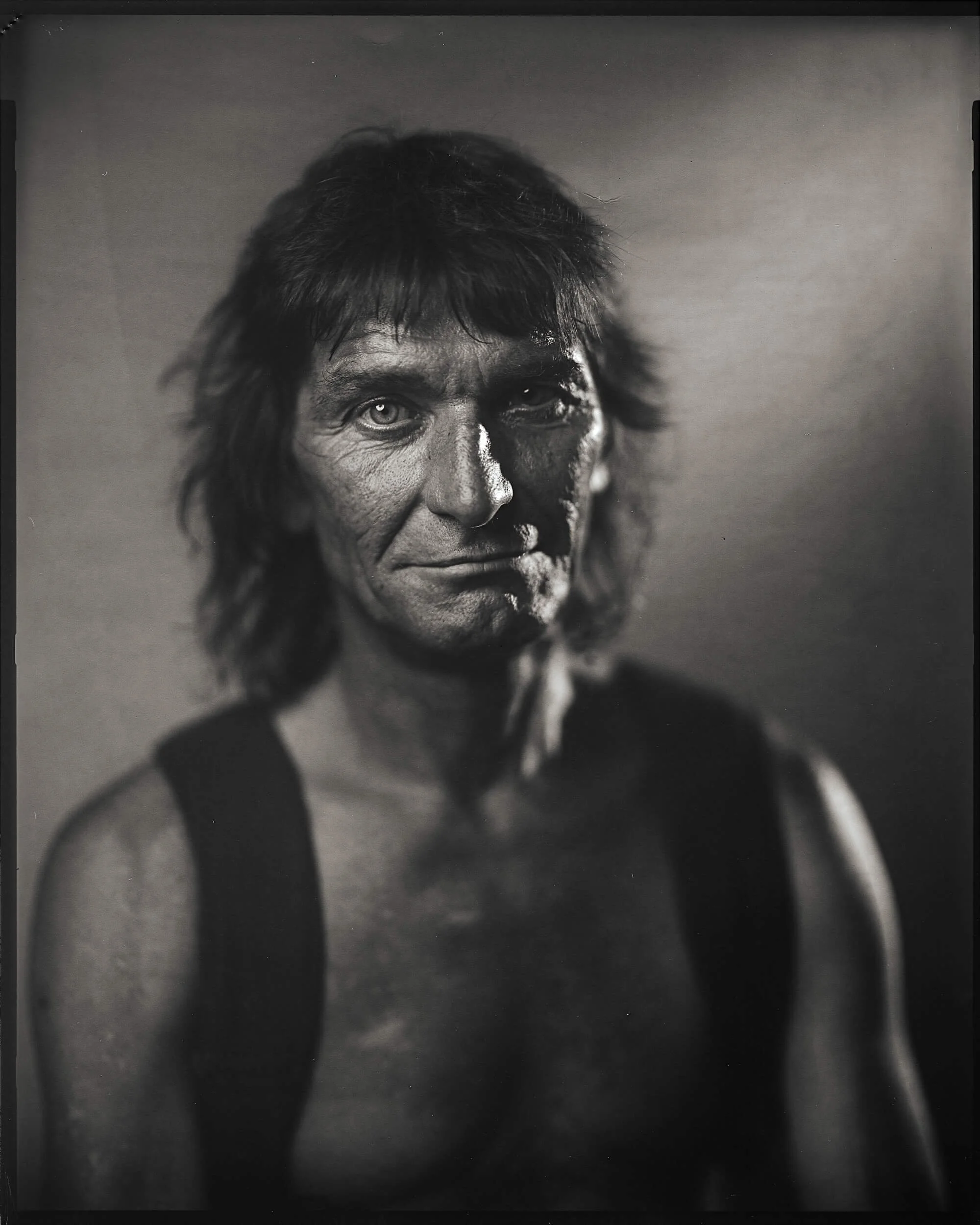 Parker J Pfister Fine Art Black and White Photography of a weathered middle aged man looking at the camera.