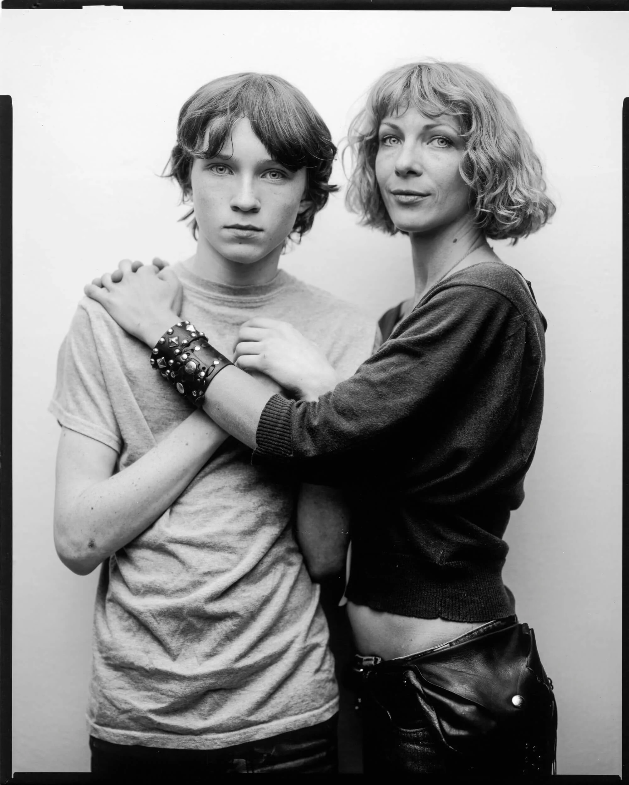 Black and White Fine Art Portrait of a young white male and older white female standing together looking at the camera- Parker J Pfister
