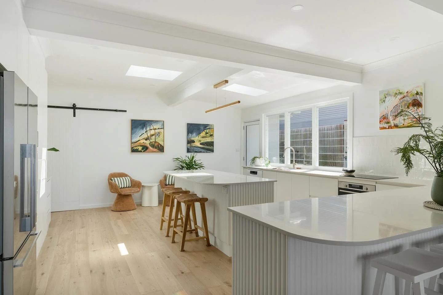 -Seaside parade -
Natural light flooded the 1960s cottage thanks to clever engineering.
The client's own artwork steals the show!