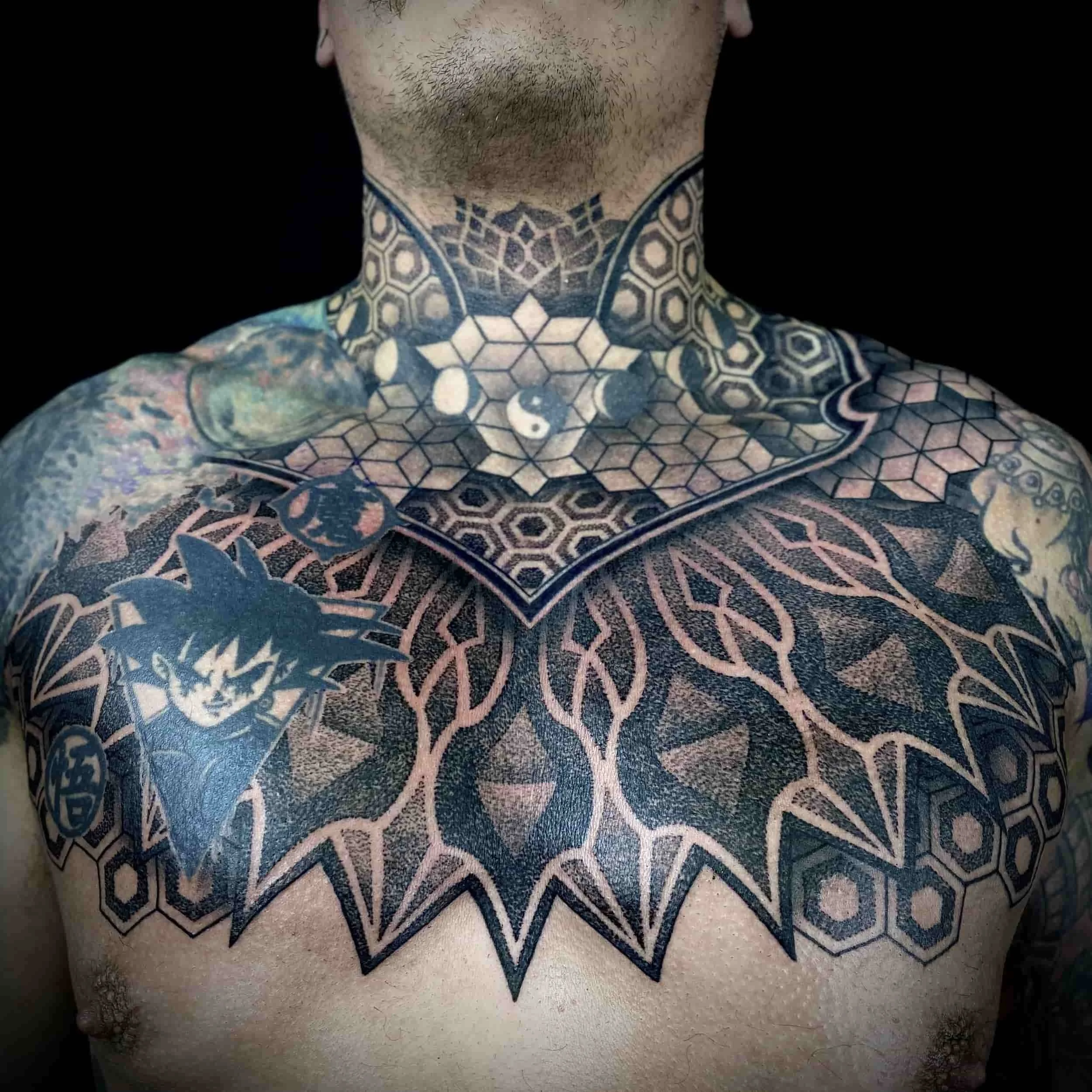 Blackwork, geometric, dotwork throat and chest tattoo.  Victoria, BC tattoo artist Cohen Floch created and the tattoo shop (Paradgim).
