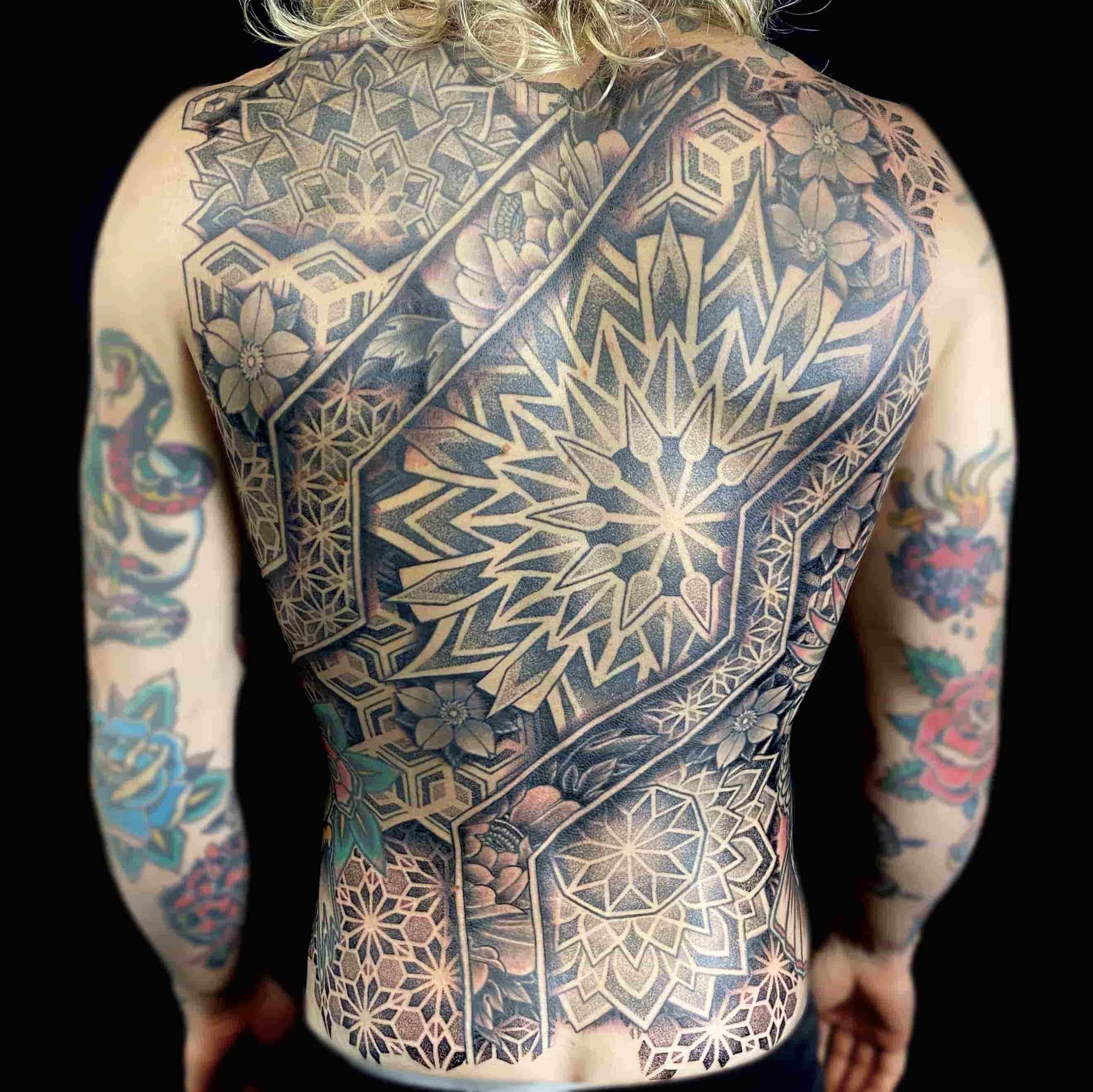Geometric Dotwork Backpiece Tattoo.  A large intricate backpiece tattoo with bold geometric lines and intricate mandalas.