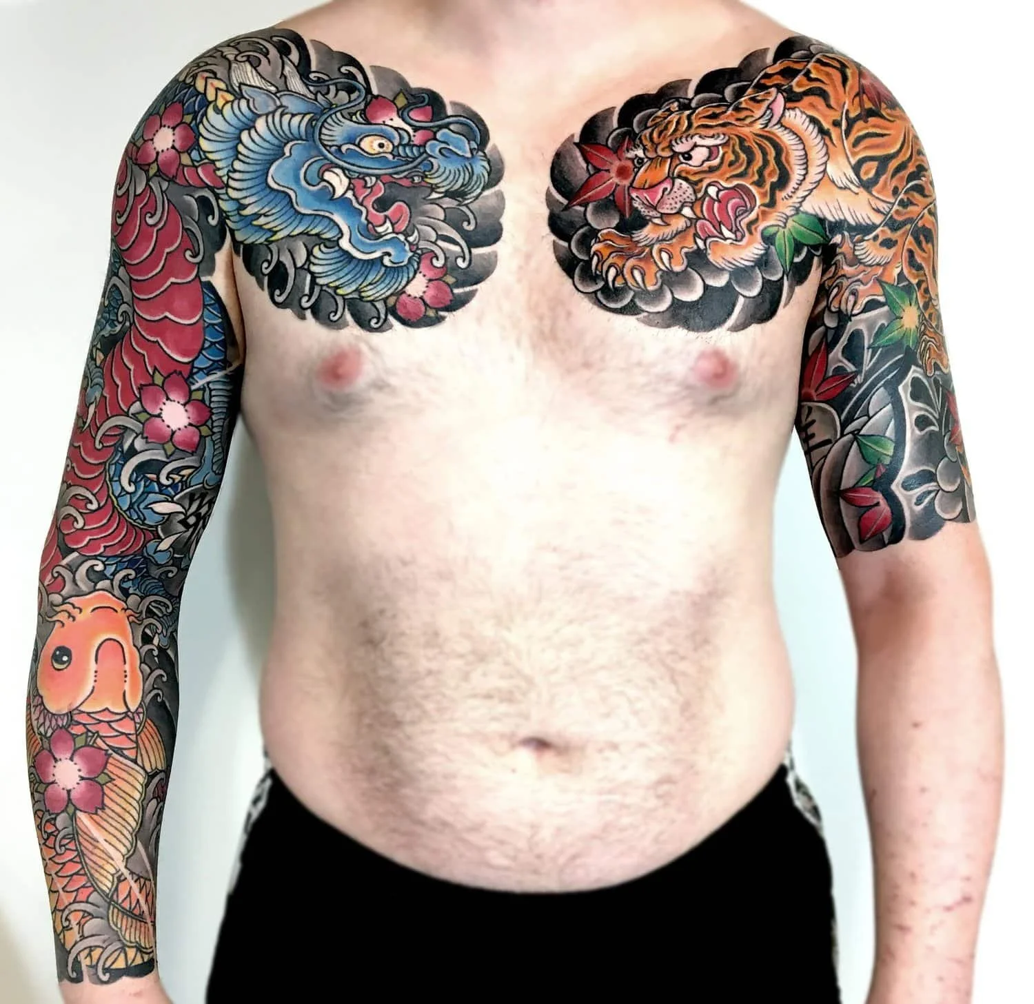 Japanese Tattoo Sleeves and Chest Plates.  A colorful dragon sleeve along with koi fish and a tiger.  Large, vibrant, irezumi tattoos.