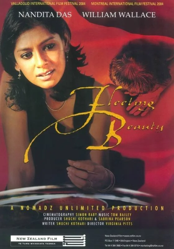 Poster for short film 'Fleeting Beauty' featuring Nandita Das and William Wallace, with a woman looking at a mirror and a red background.