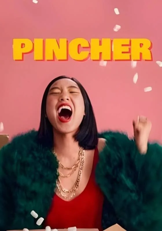 Poster for the web series 'Pincher'. A woman with black hai, red top, green fuzzy coat, and gold jewelry, throws a handful of something white against a pink background, with the word 'PINCHER' in large yellow letters above her.