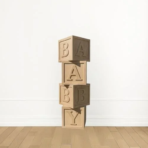 Four wooden blocks with embossed letters stacked vertically against a white wall on a wooden floor.
