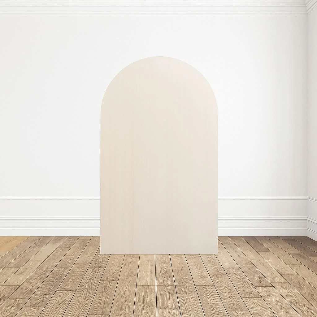 Empty white room with wooden flooring and an arched white panel or partition in the center.