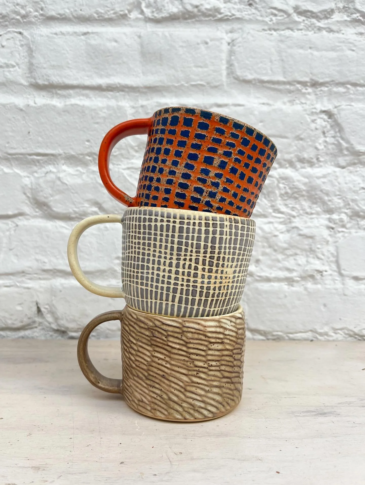 New mugs 🙏 

I think my fav is the blue &amp; off white but pretty hard to choose. Excited to be exploring sgraffito further !! 

All sold thank you <3

#ceramics #stoneware #underglaze