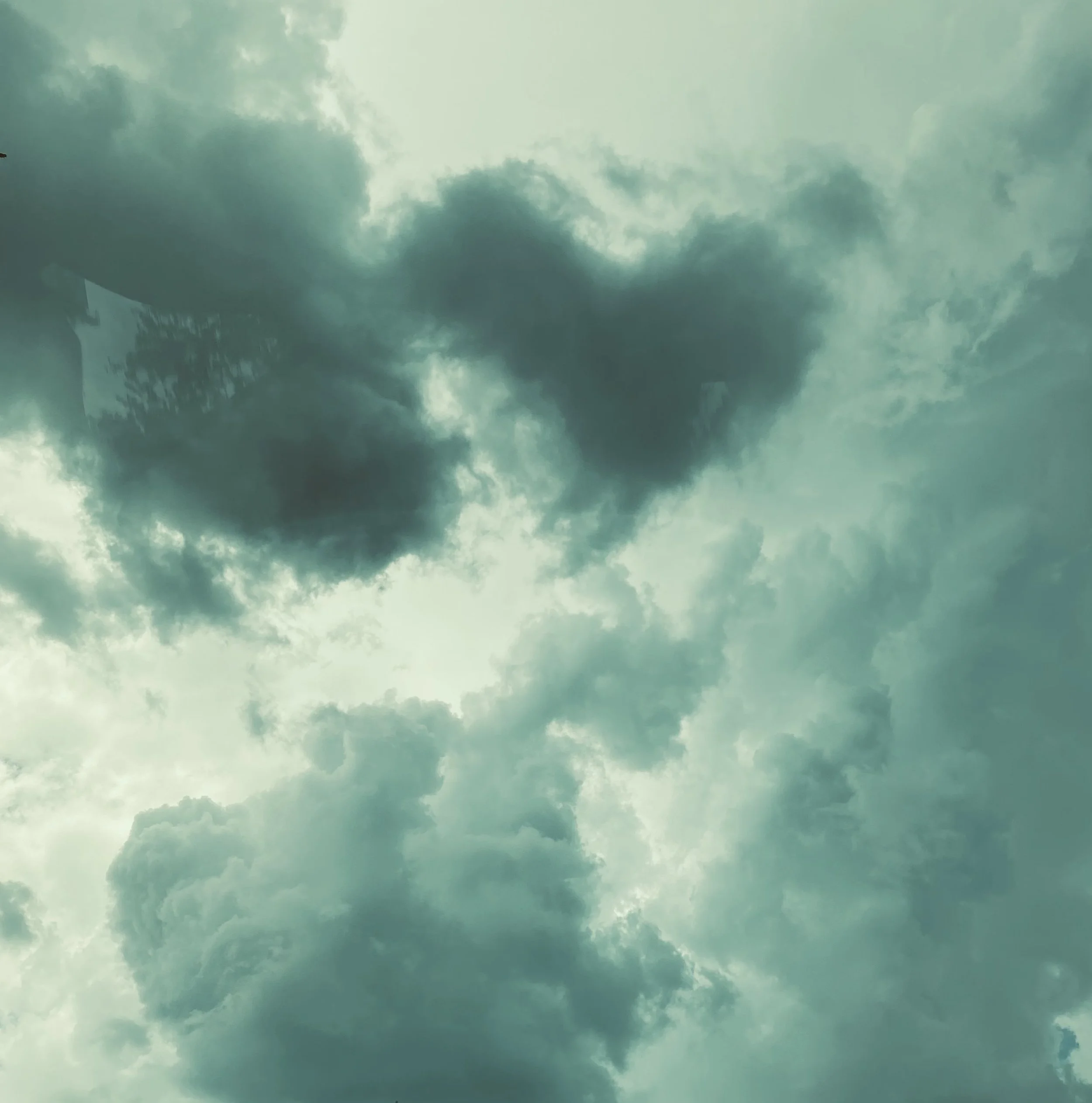 Cloudy sky with dark clouds and sunlight peeking through