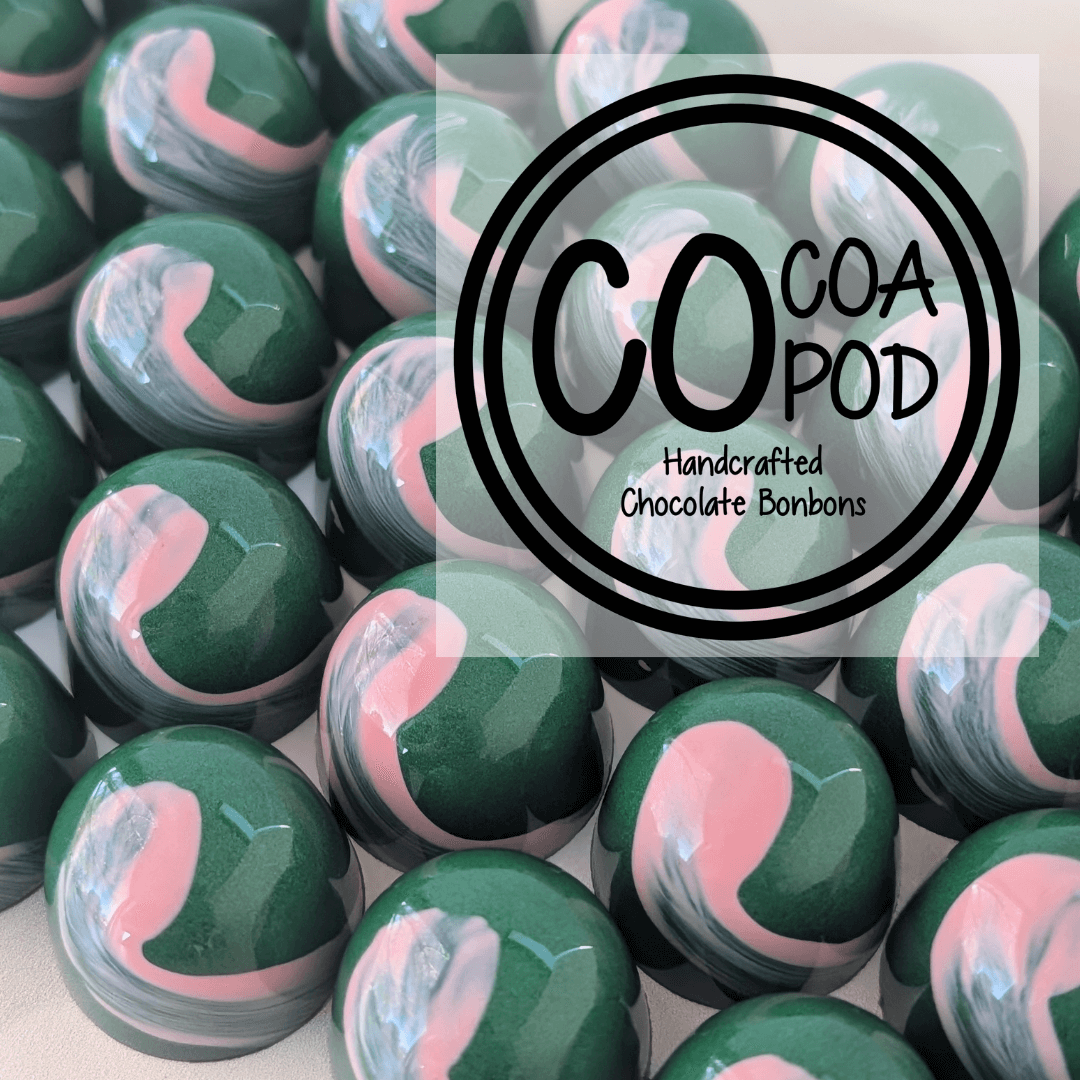 CoCoa Pod logo over artisan chocolates with a shiny green and pick shell