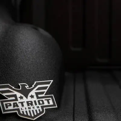 Black truck bed liner with Patriot Liner logo